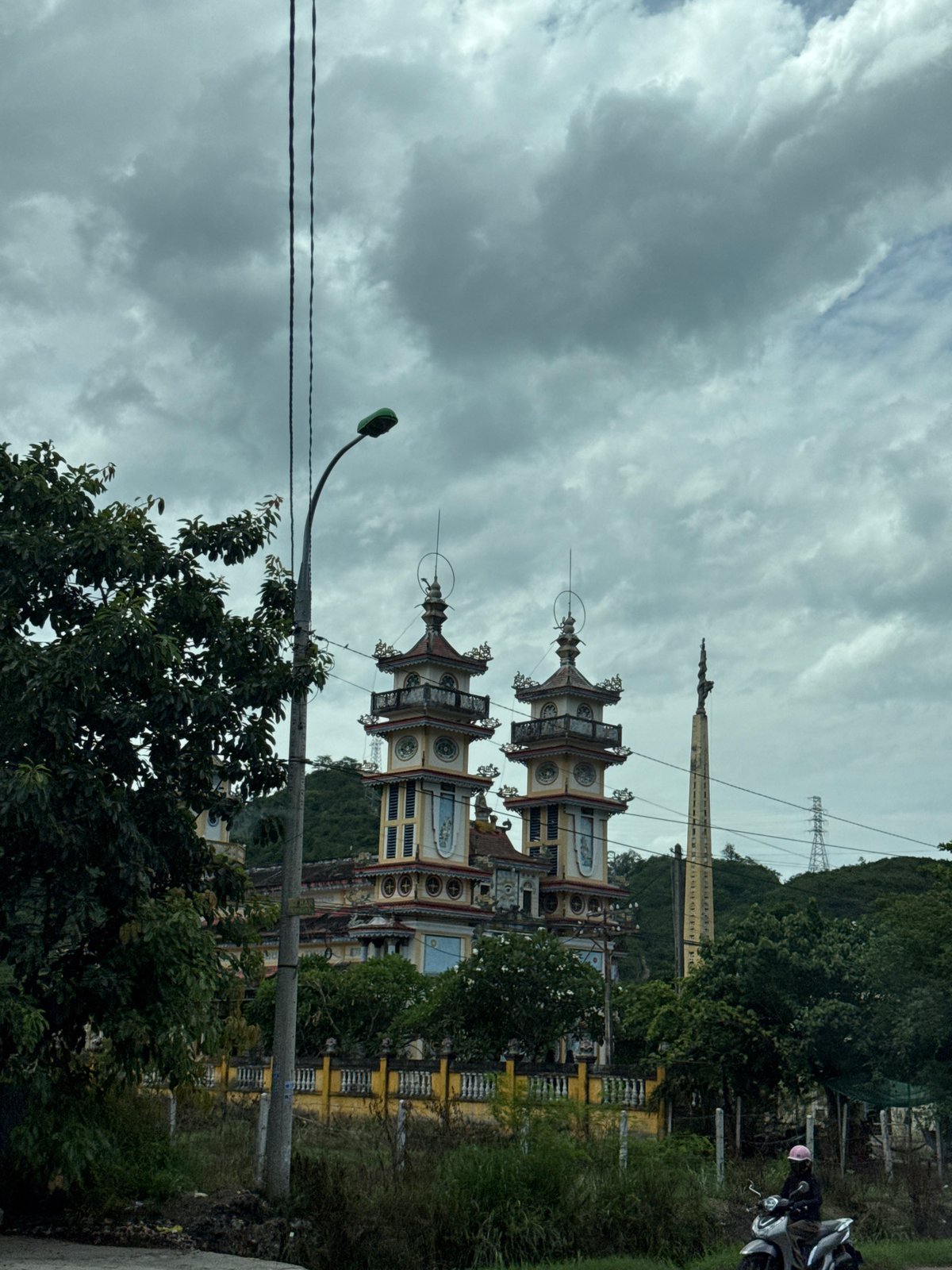 Driving past a temple on Highway QL1, Vĩnh Lương