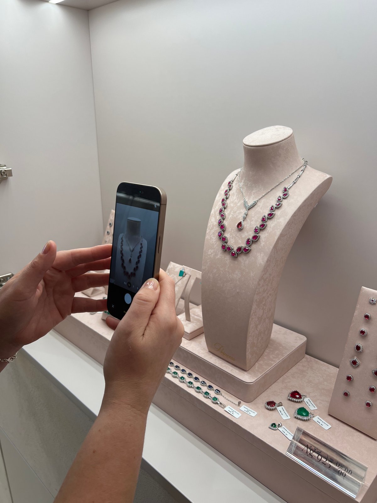Selfies and jewelry browsing in a bright minimalist store
