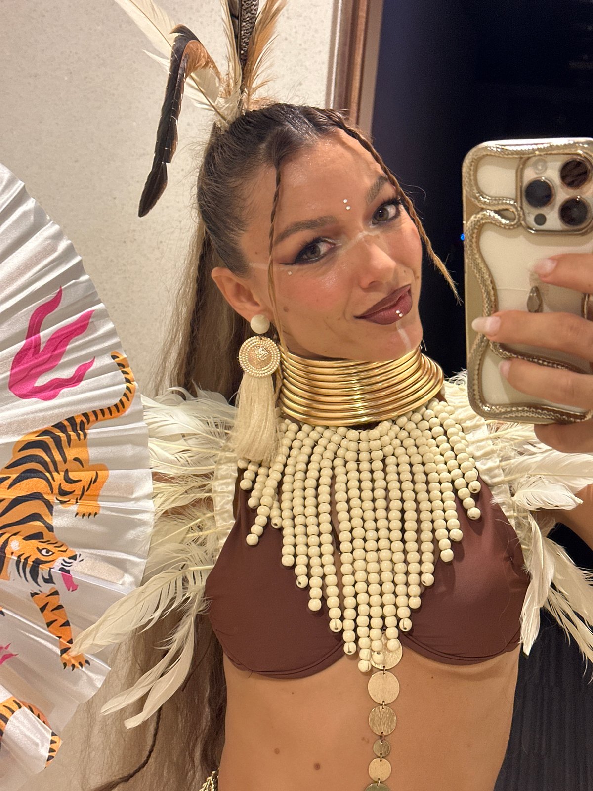 Elaborate feathered costume selfies in a Ko Samui restroom
