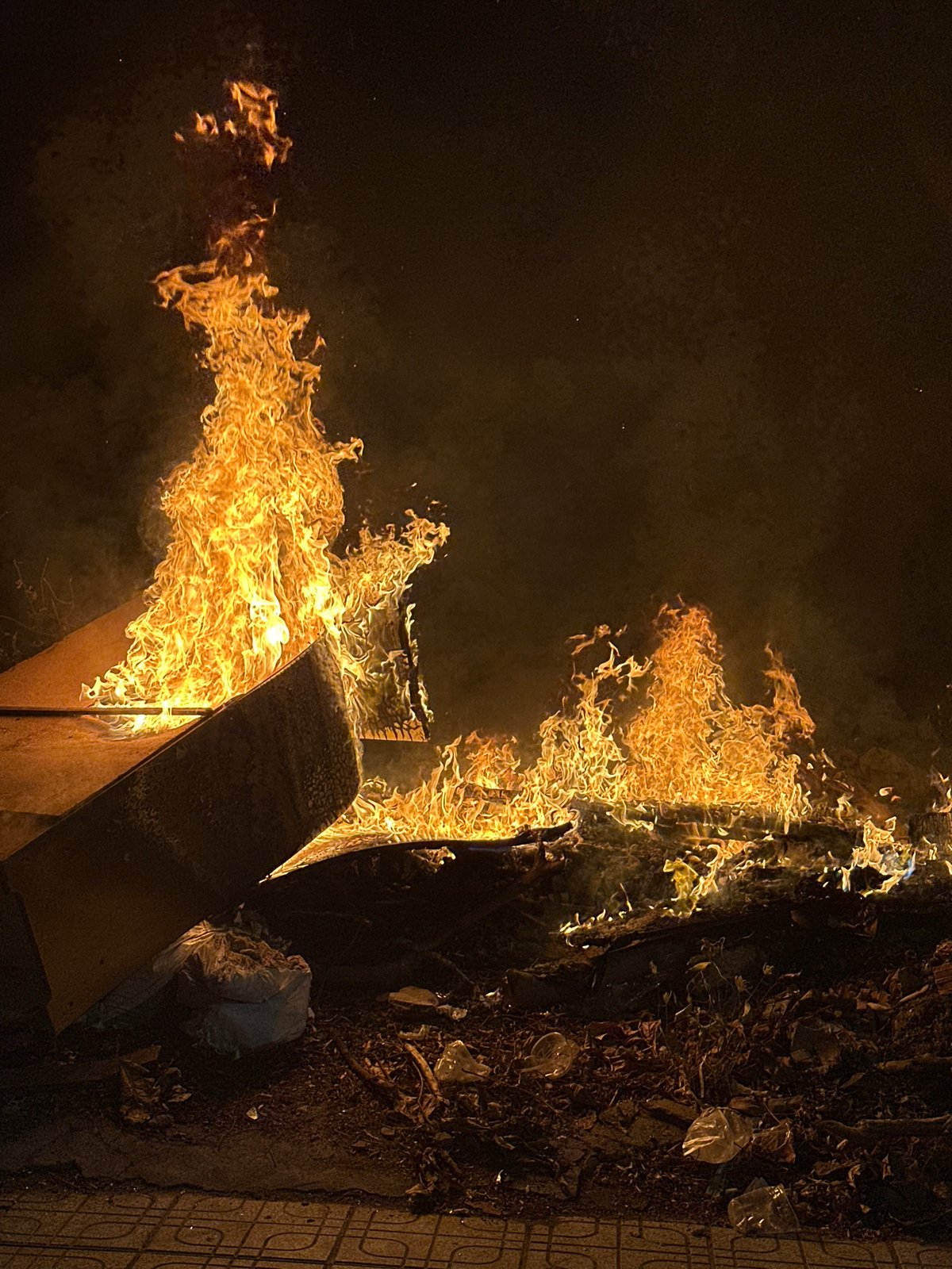 Street fire burns debris in Vietnam tourist district