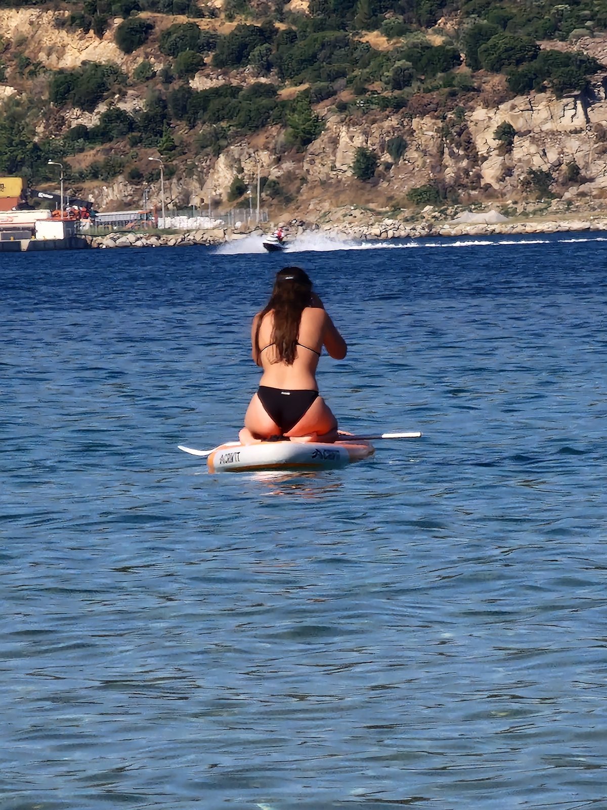 Boats and paddleboard on a Greek summer afternoon