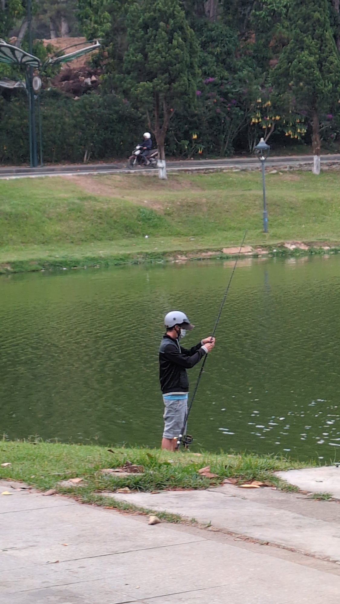 Man fishing at Xuân Hương Lake, Đà Lạt