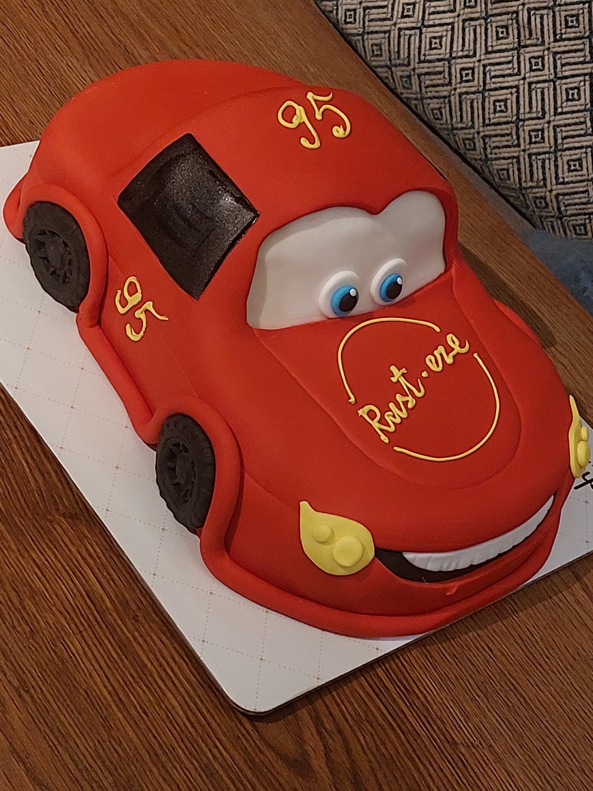 Celebration items captured: themed cake, flower arrangements, rose bouquet