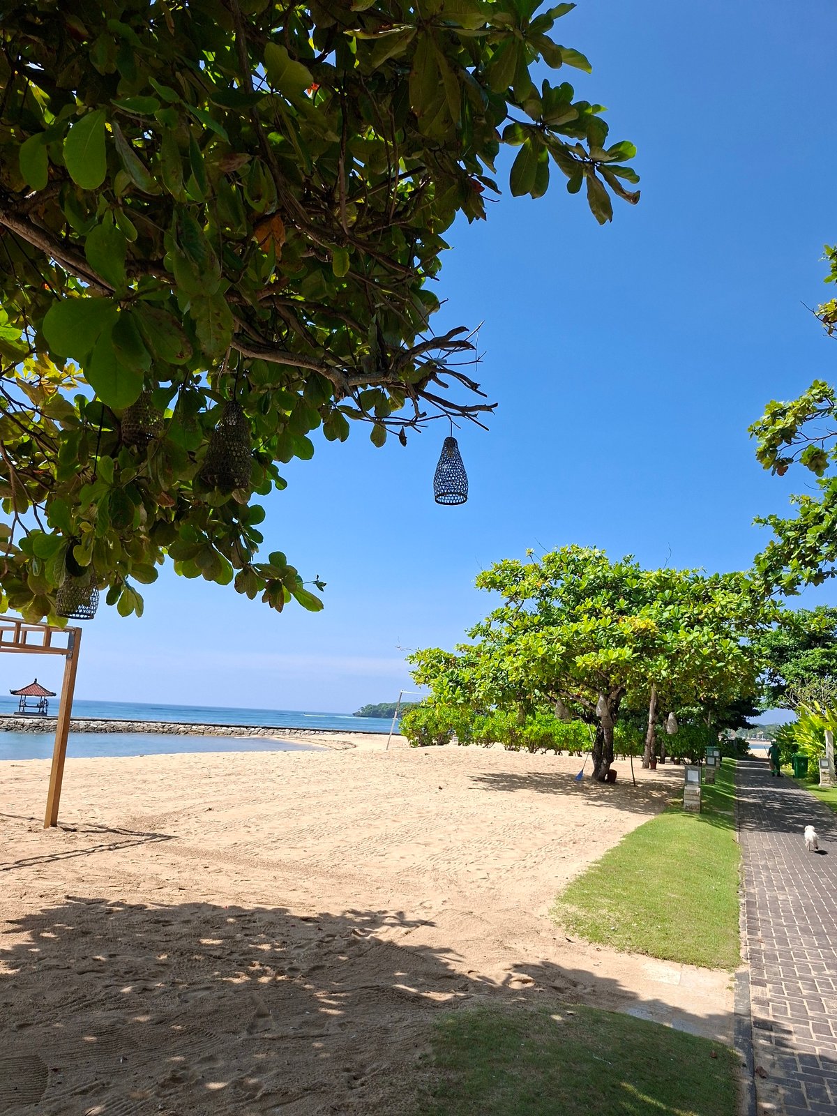 Tourist documents sunny morning at Kuta Selatan beach resort