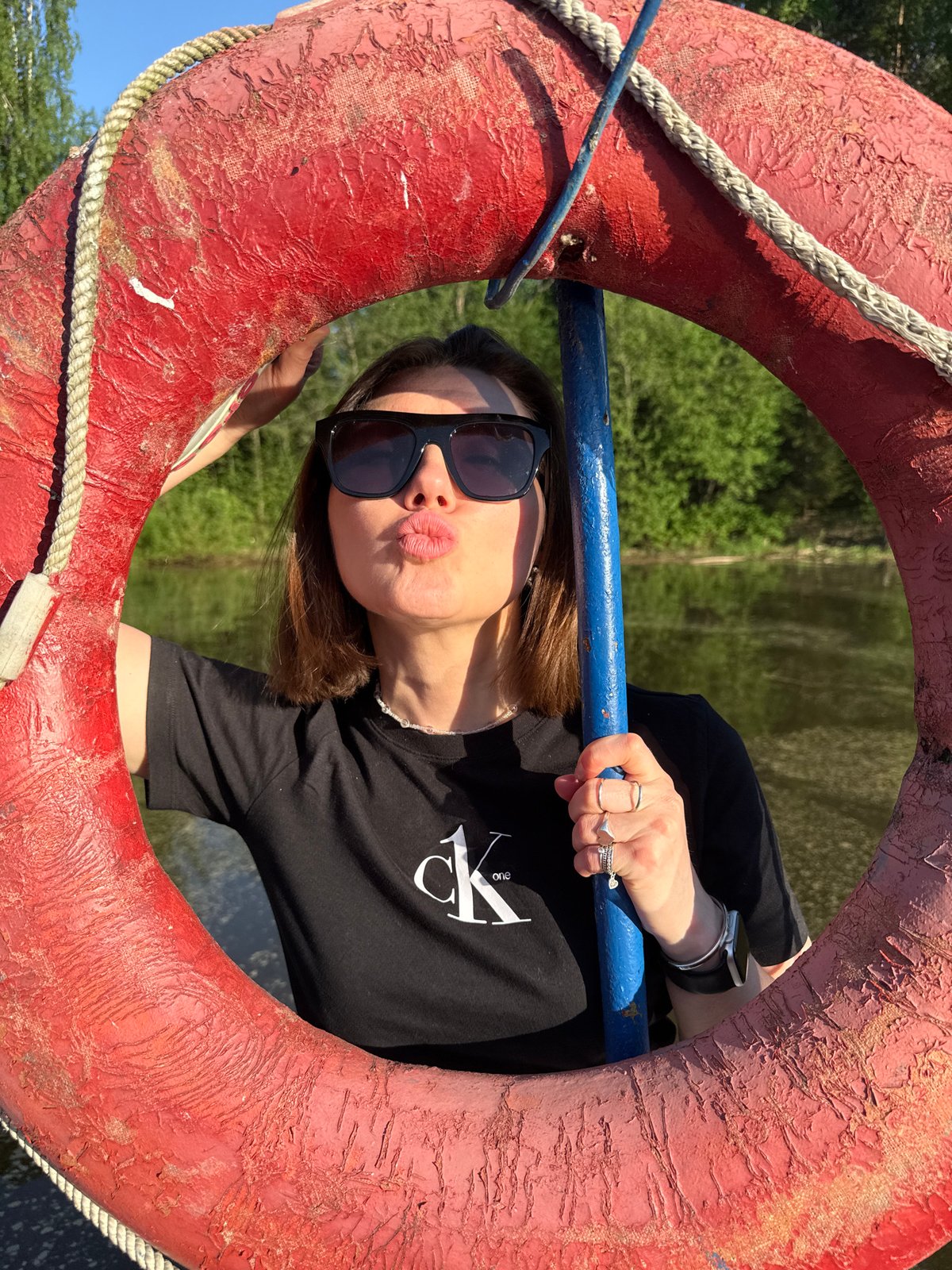 Woman poses playfully with life preserver in Chaikovsky