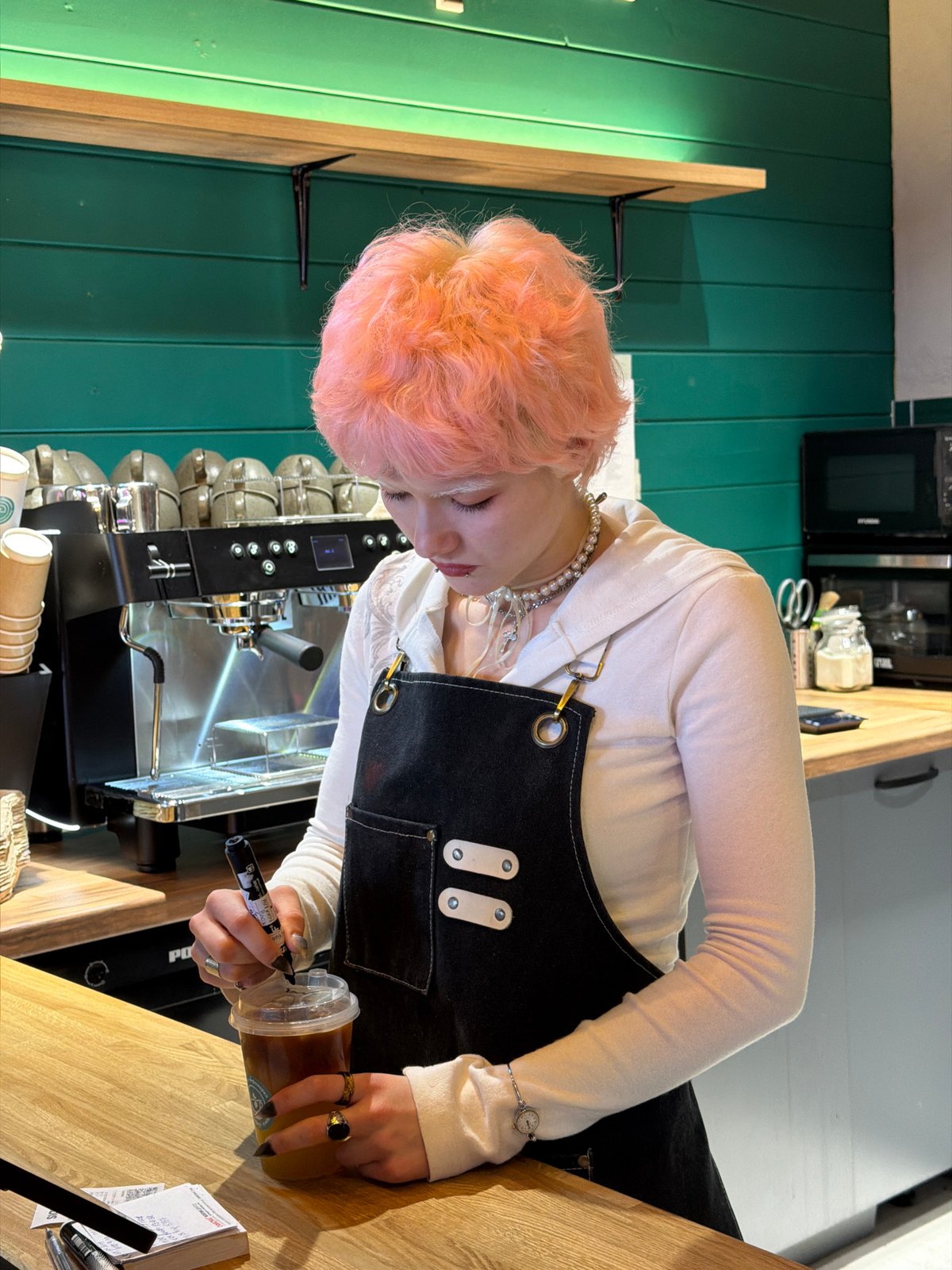 Café worker serves decorated iced tea in Засечное, Russia
