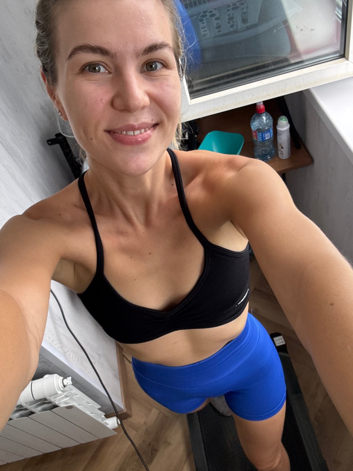 Home workout session with city views and a cat nearby