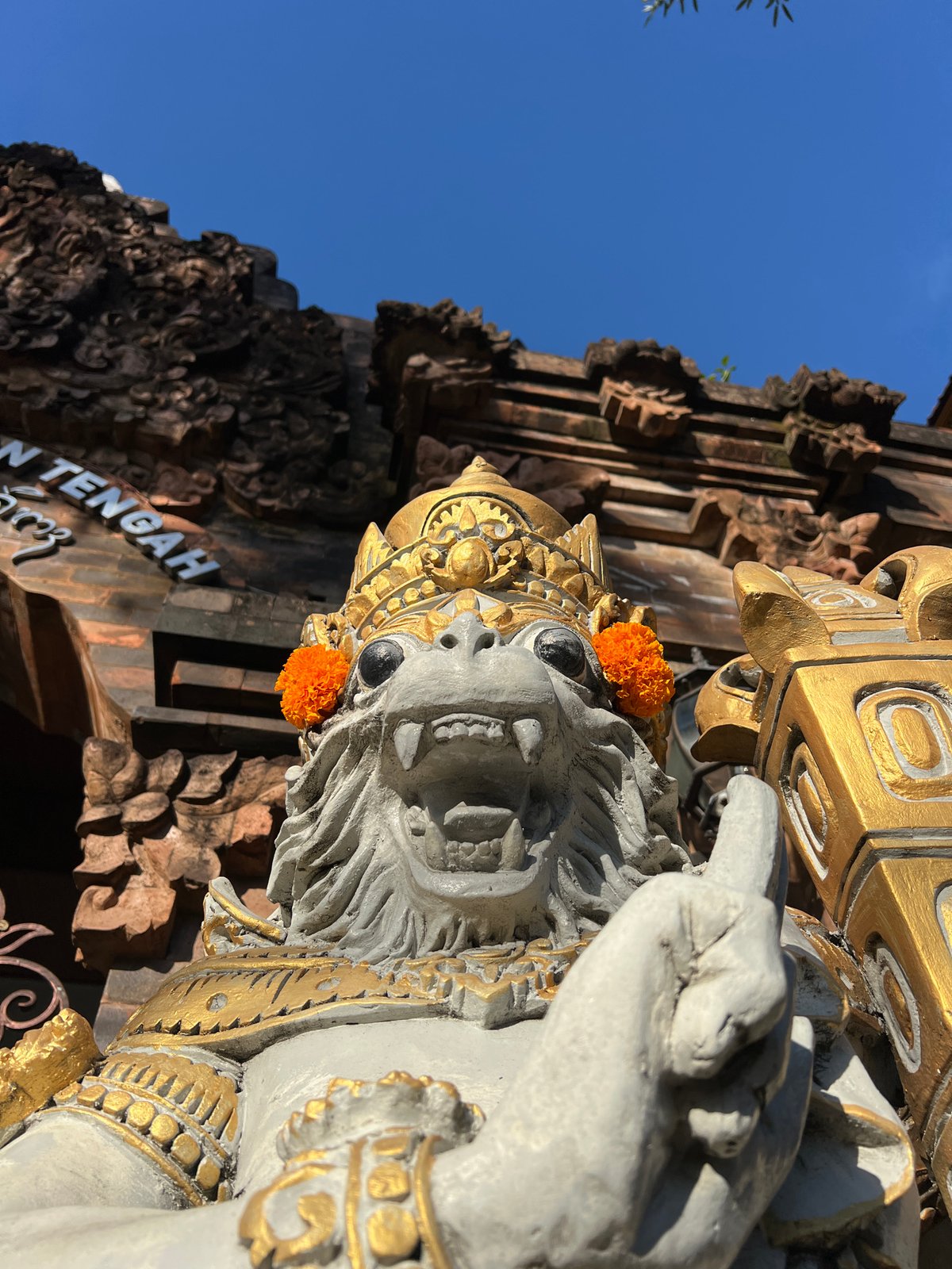 Temple visit documented in Kuta with traditional offerings, statues