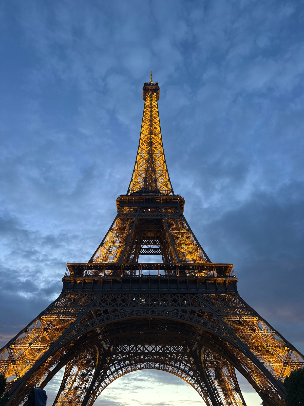 Eiffel Tower glows golden during Paris twilight hour