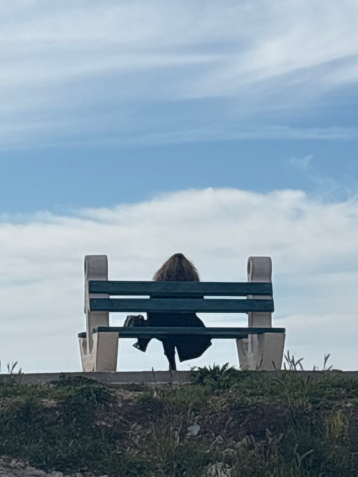 Person sits alone on park bench in Bar, Montenegro