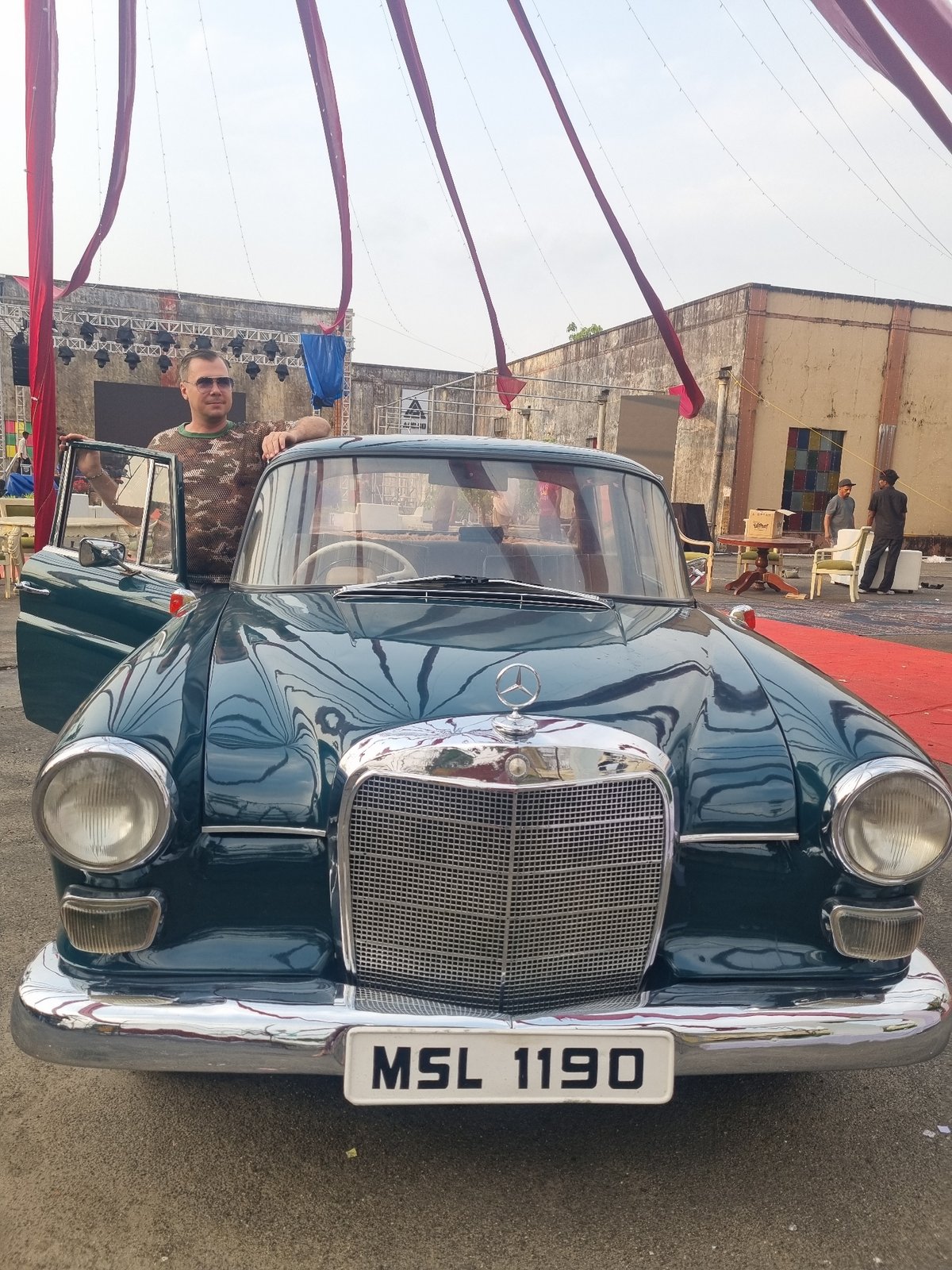 Vintage Mercedes spotted with door open, man in sunglasses