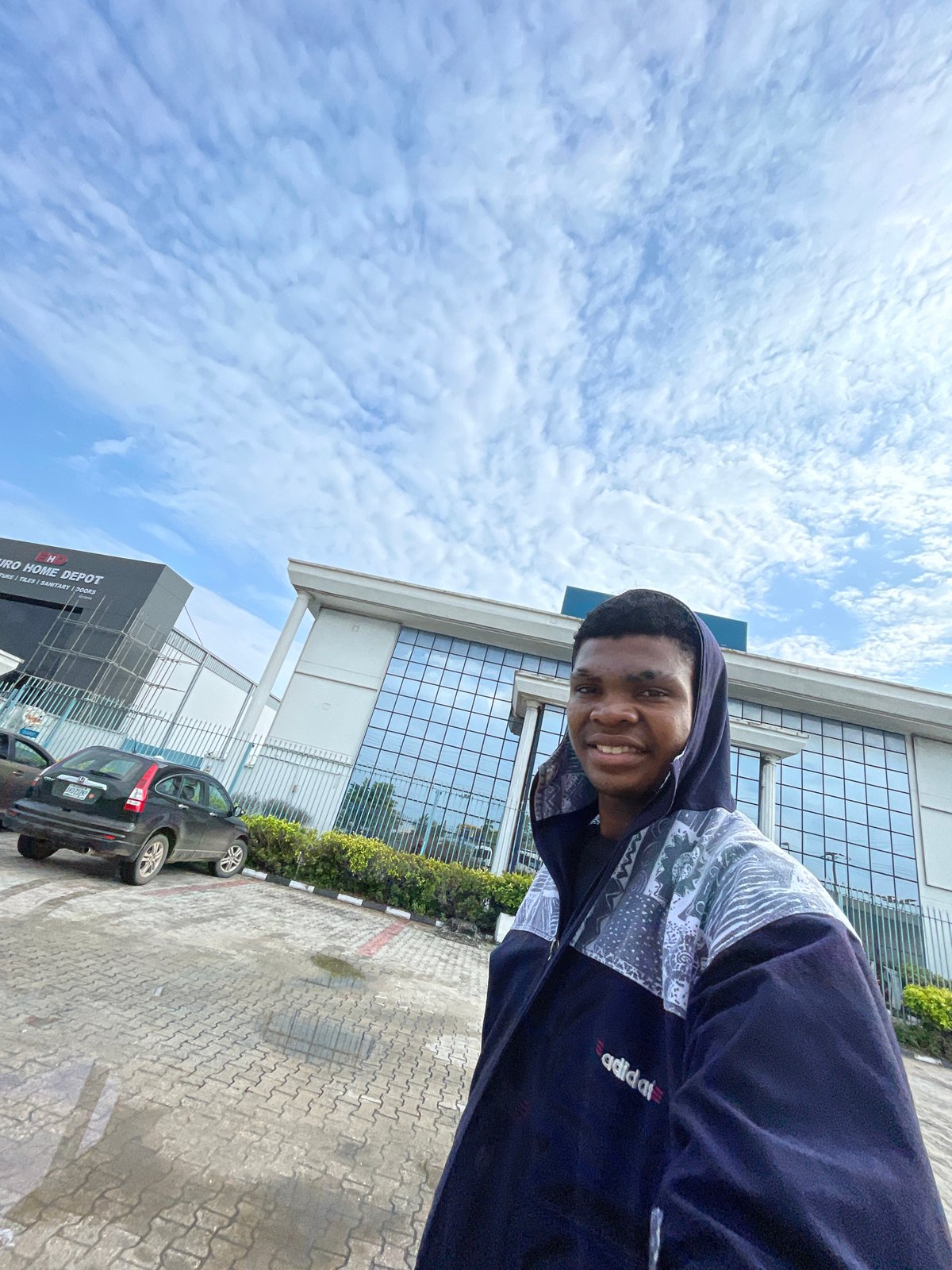 Young man takes morning selfies near Ilado commercial district