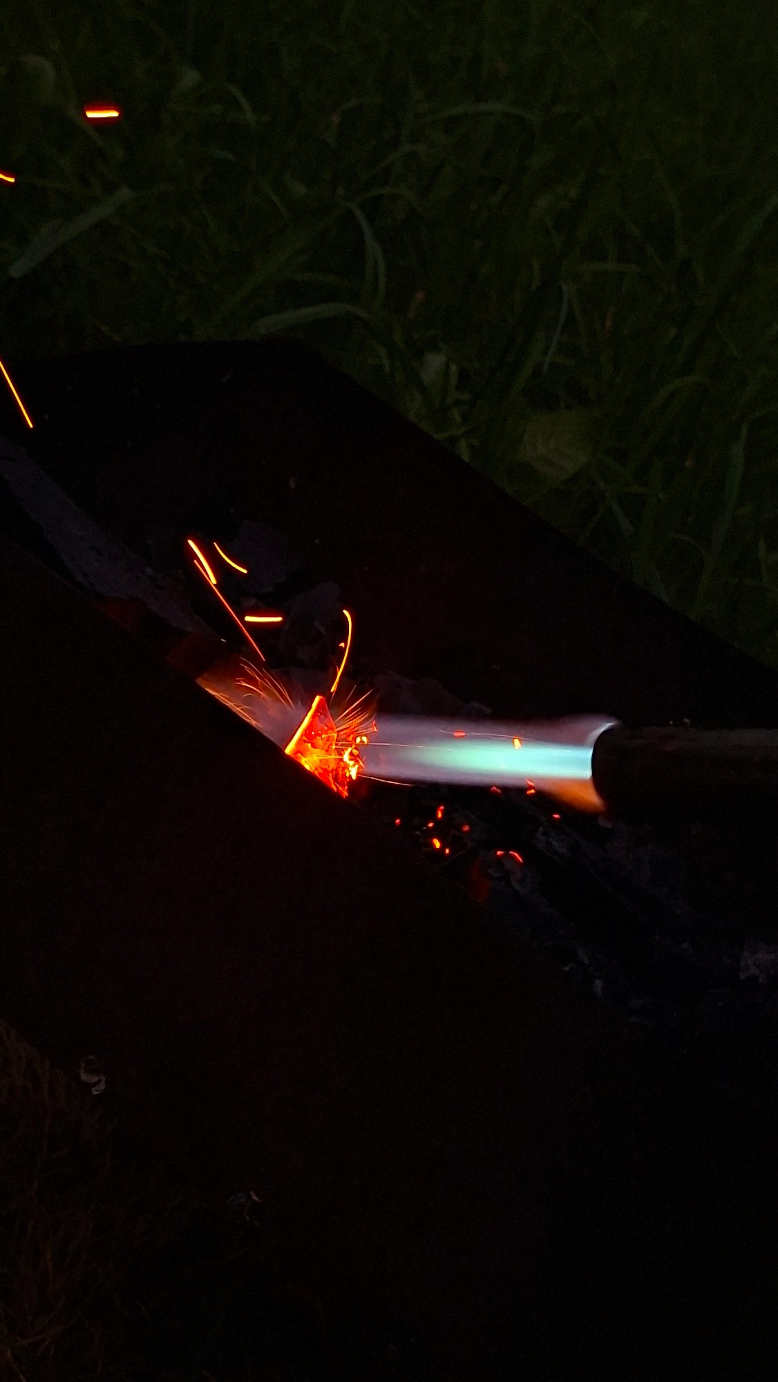 Midsummer backyard bonfire night in rural Belarus