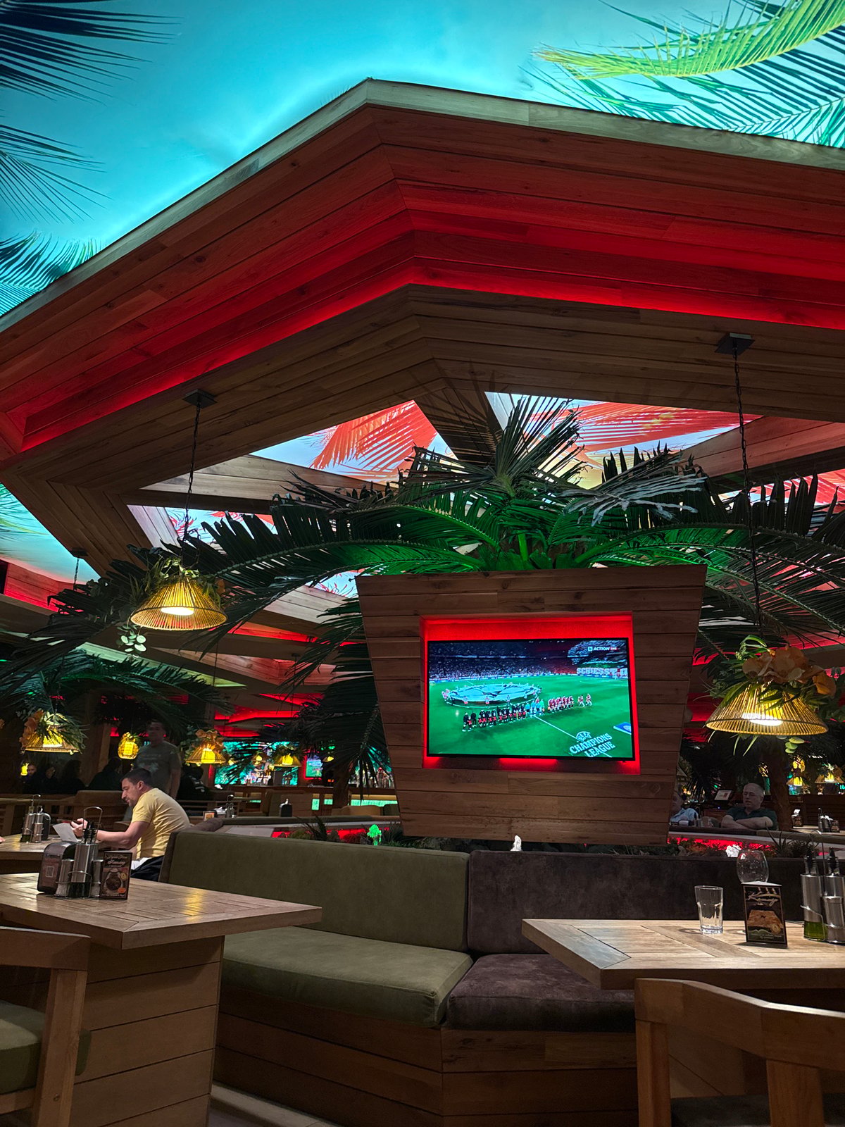 Sofia resident documents local bar interior, aircraft contrails overhead