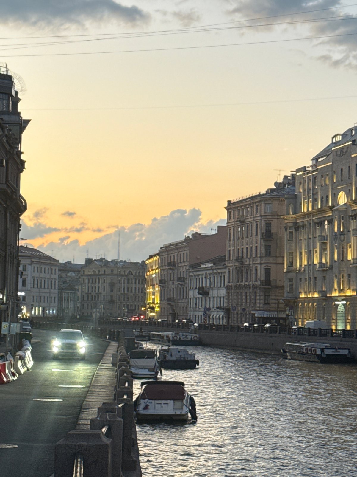 Horses, carriages, and scooters along St. Petersburg's evening streets