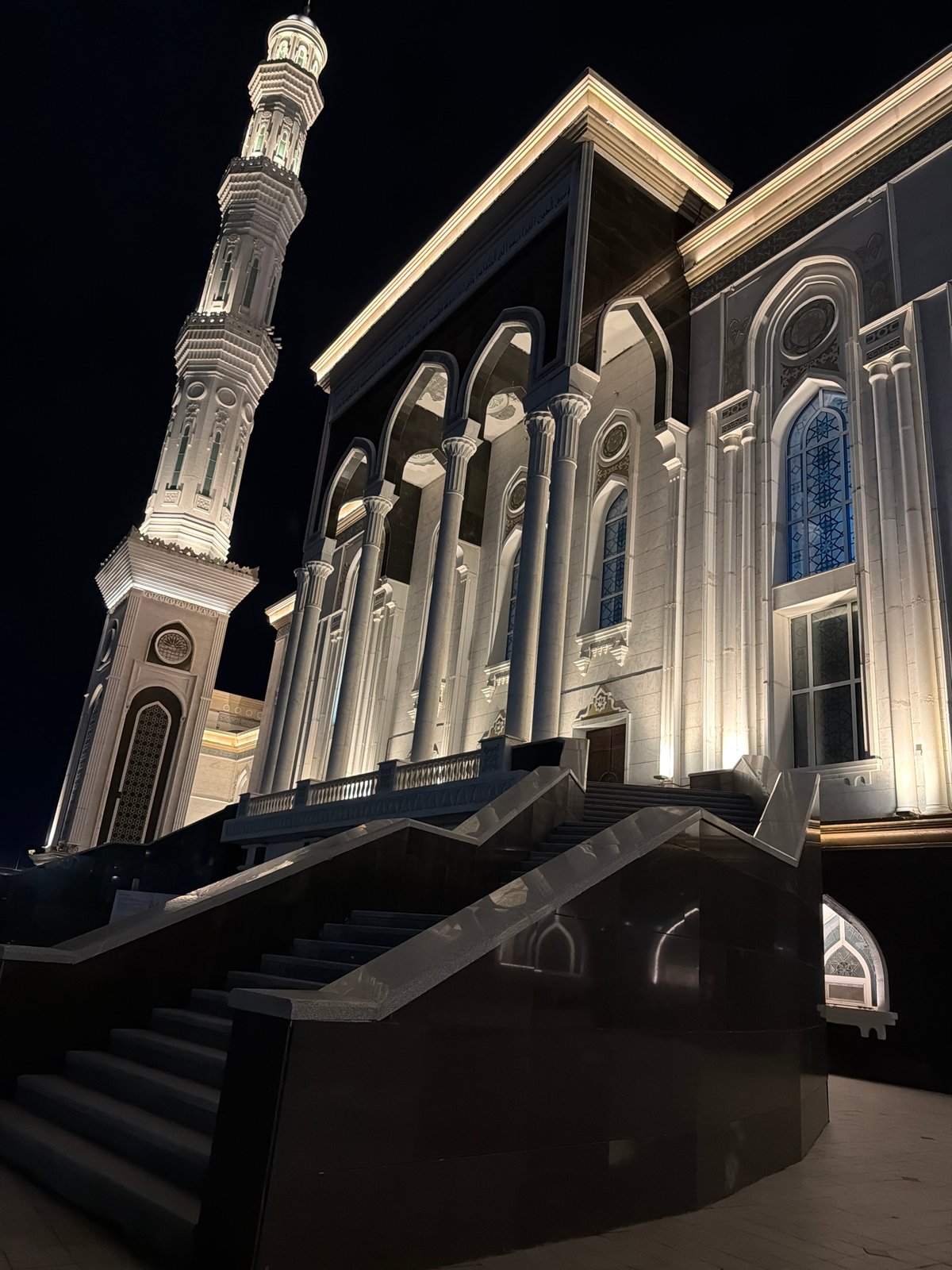 Nur-Astana Mosque glowing at night amid Astana's cityscape
