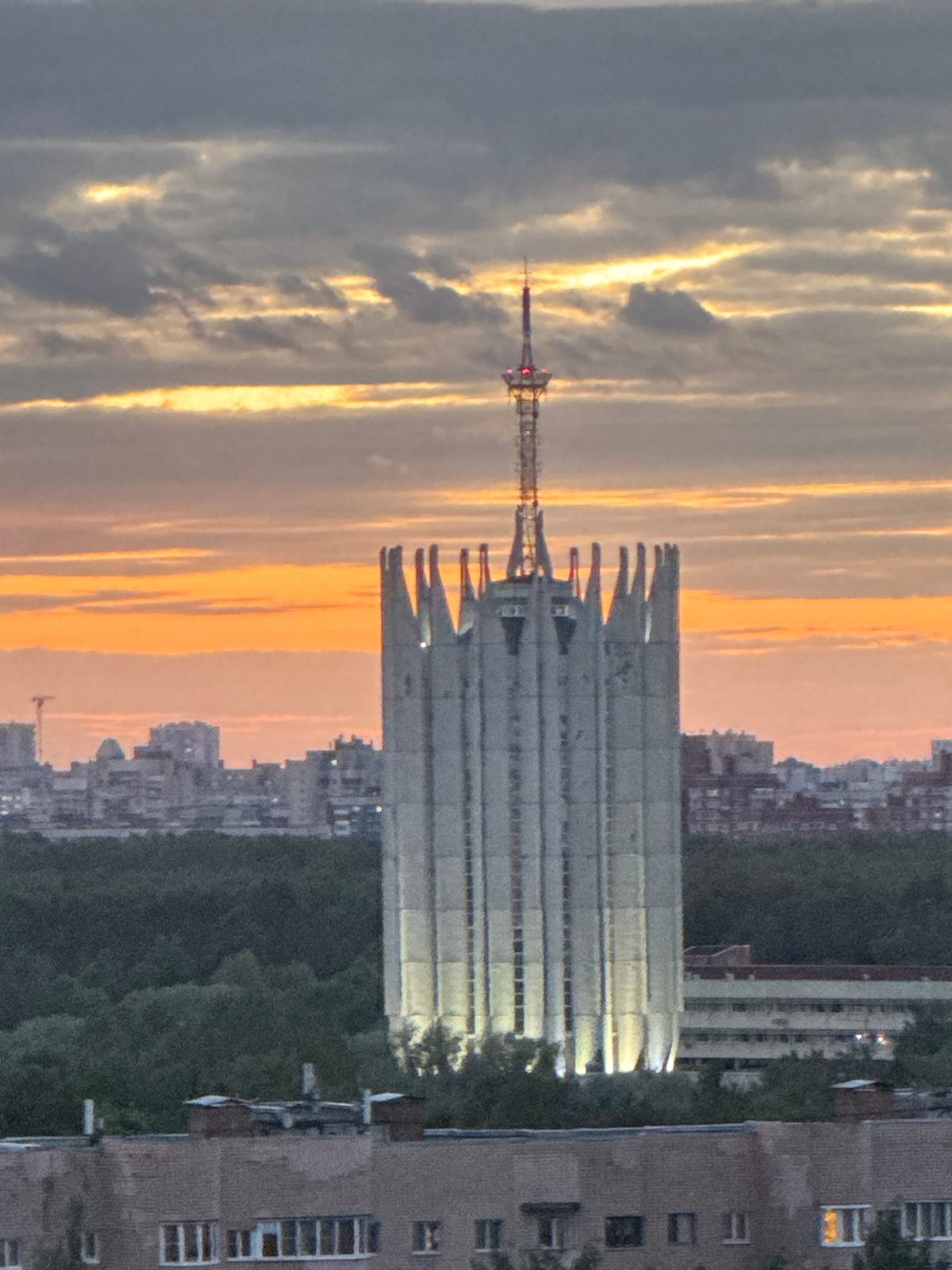 Urban sunset documented with communication tower silhouetted against colorful sky