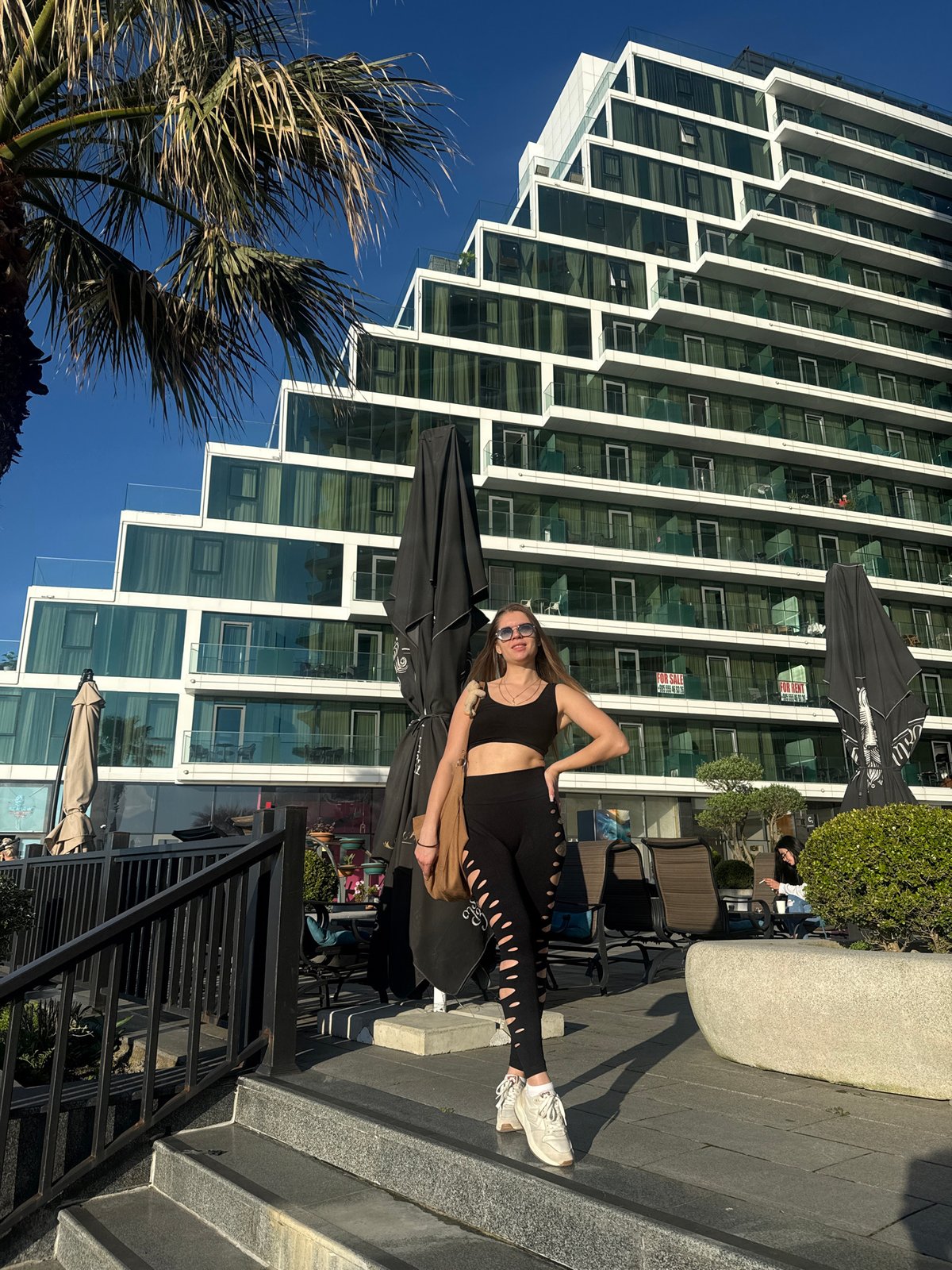 Woman in athletic wear spotted near modern building in Batumi