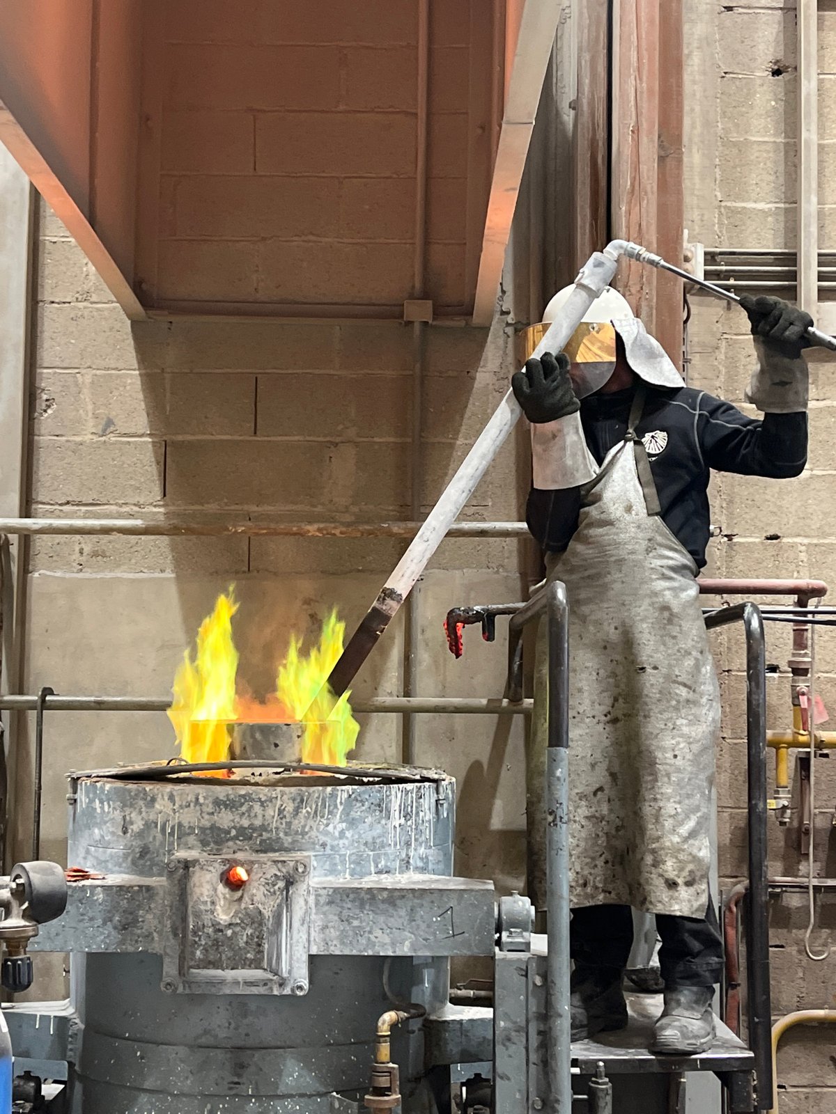 Worker conducts high-temperature operations in French industrial workshop
