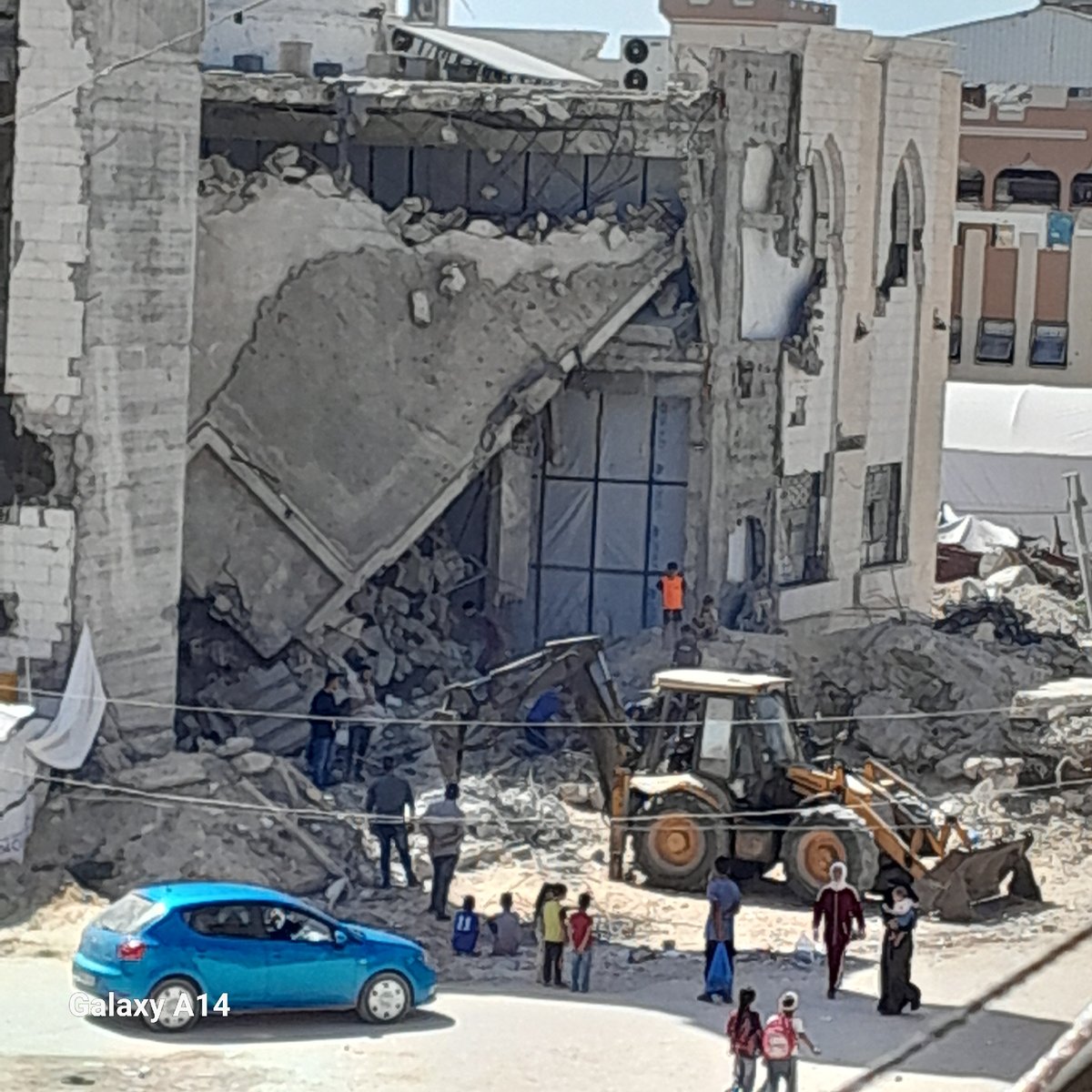 Cleanup crews work at collapsed building in Khan Yunis