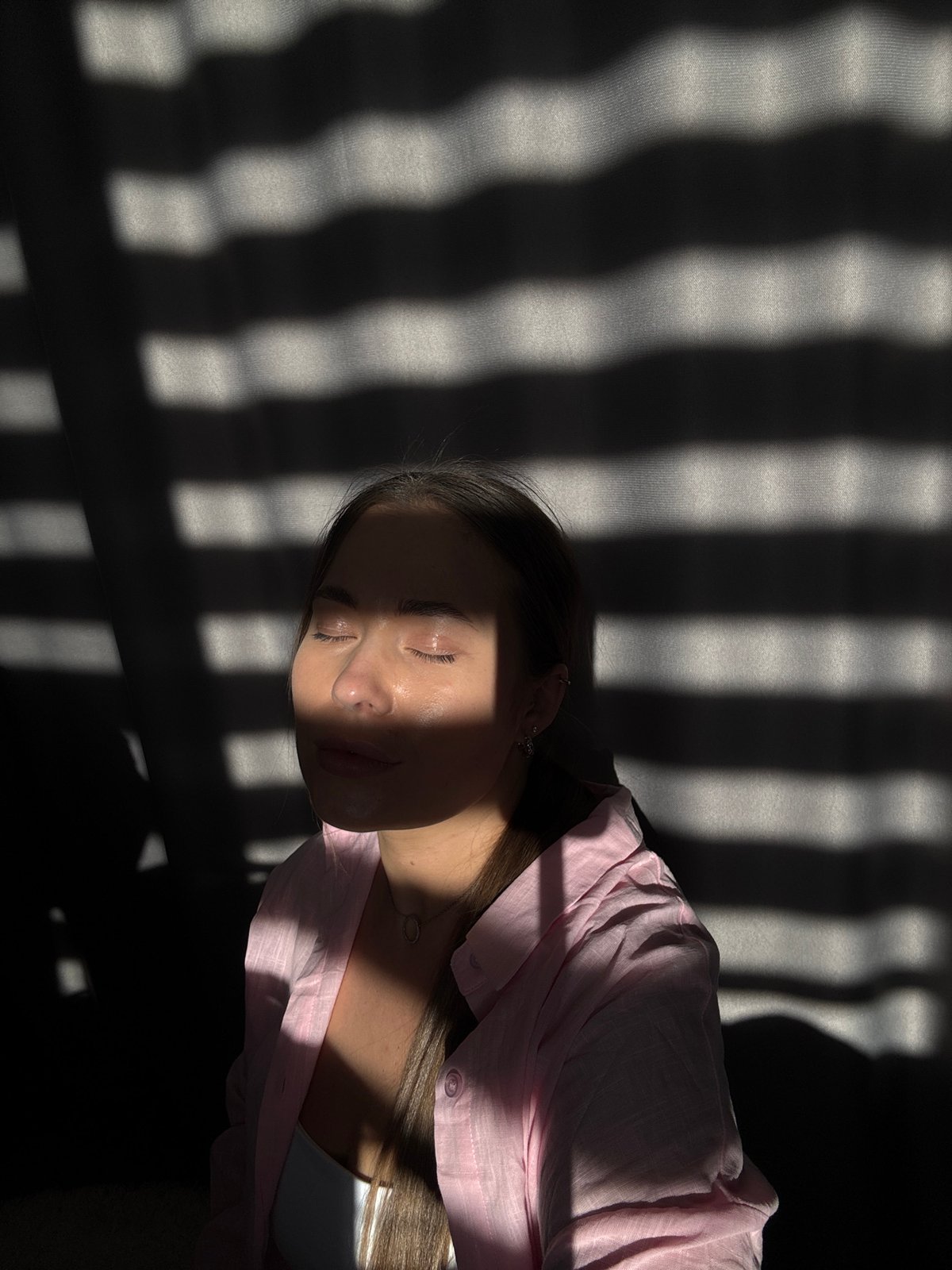 Woman photographed in dramatic sunlight patterns, Chernushka, Russia