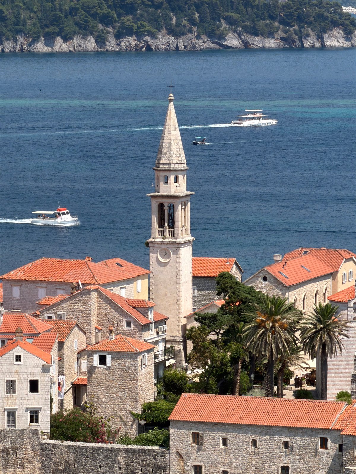 Aerial tour of Budva's Old Town, coastline, and harbor