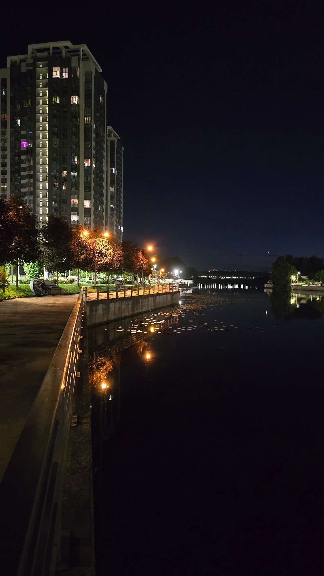 Kyiv's illuminated Dnipro embankment captured from multiple nighttime angles