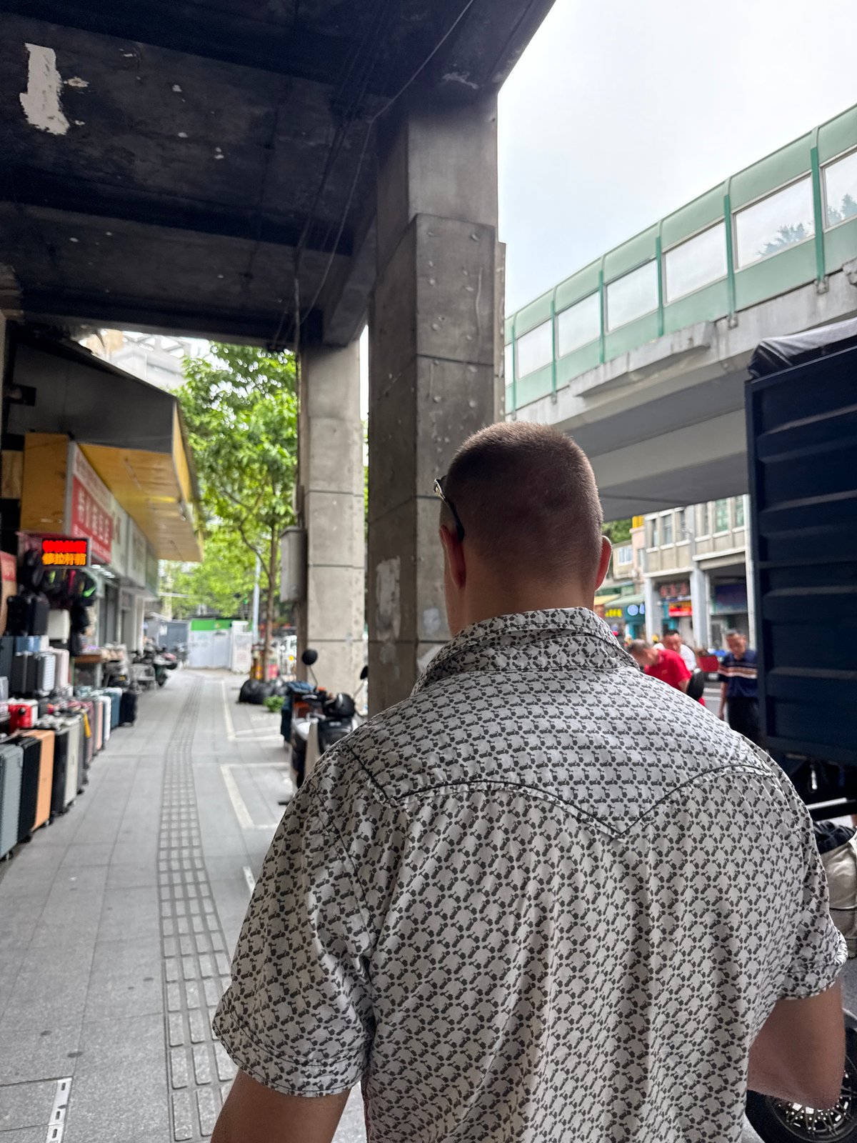 Street-level morning activity under Yuexiu District's elevated overpass