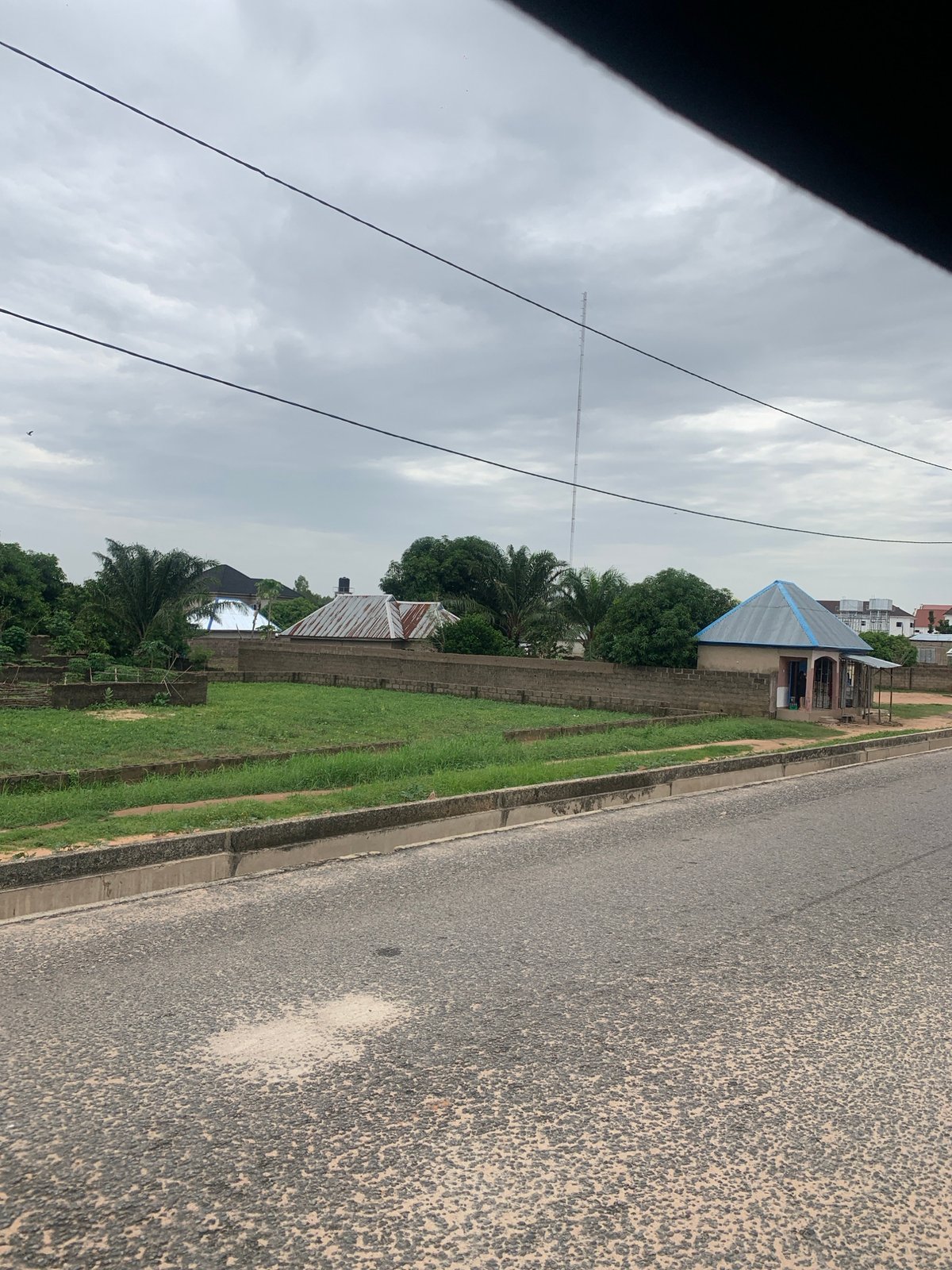 Street-level scenes around a school and event hall in Howayi, Nigeria