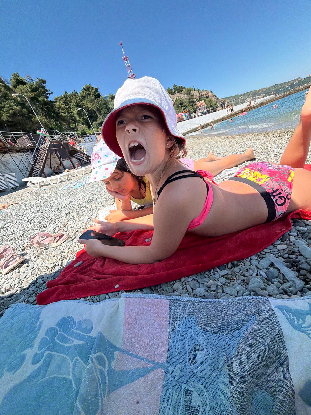 Lazy beach morning on the pebbles in Partenit