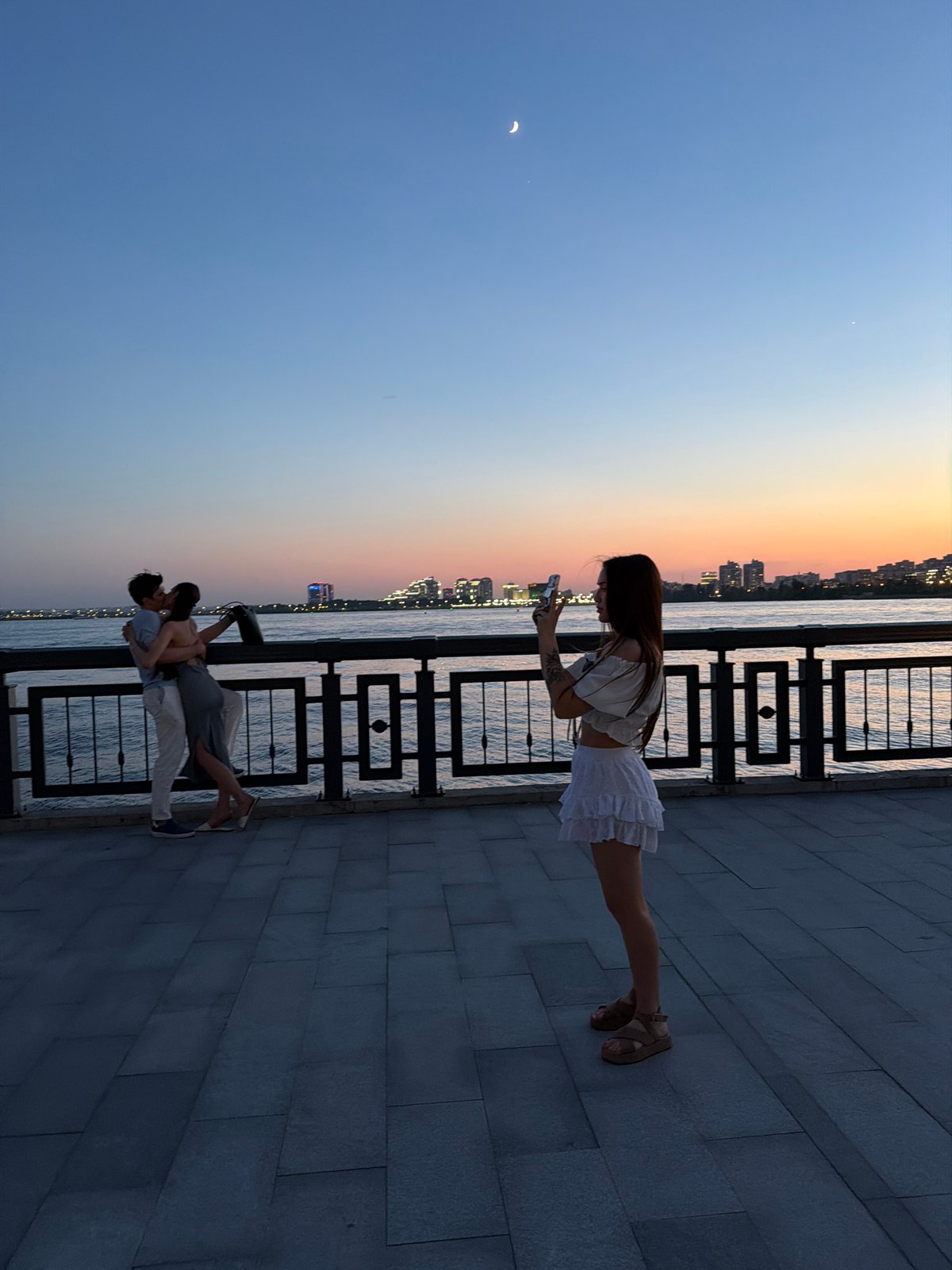 Urban twilight scene with modern buildings and casual interactions