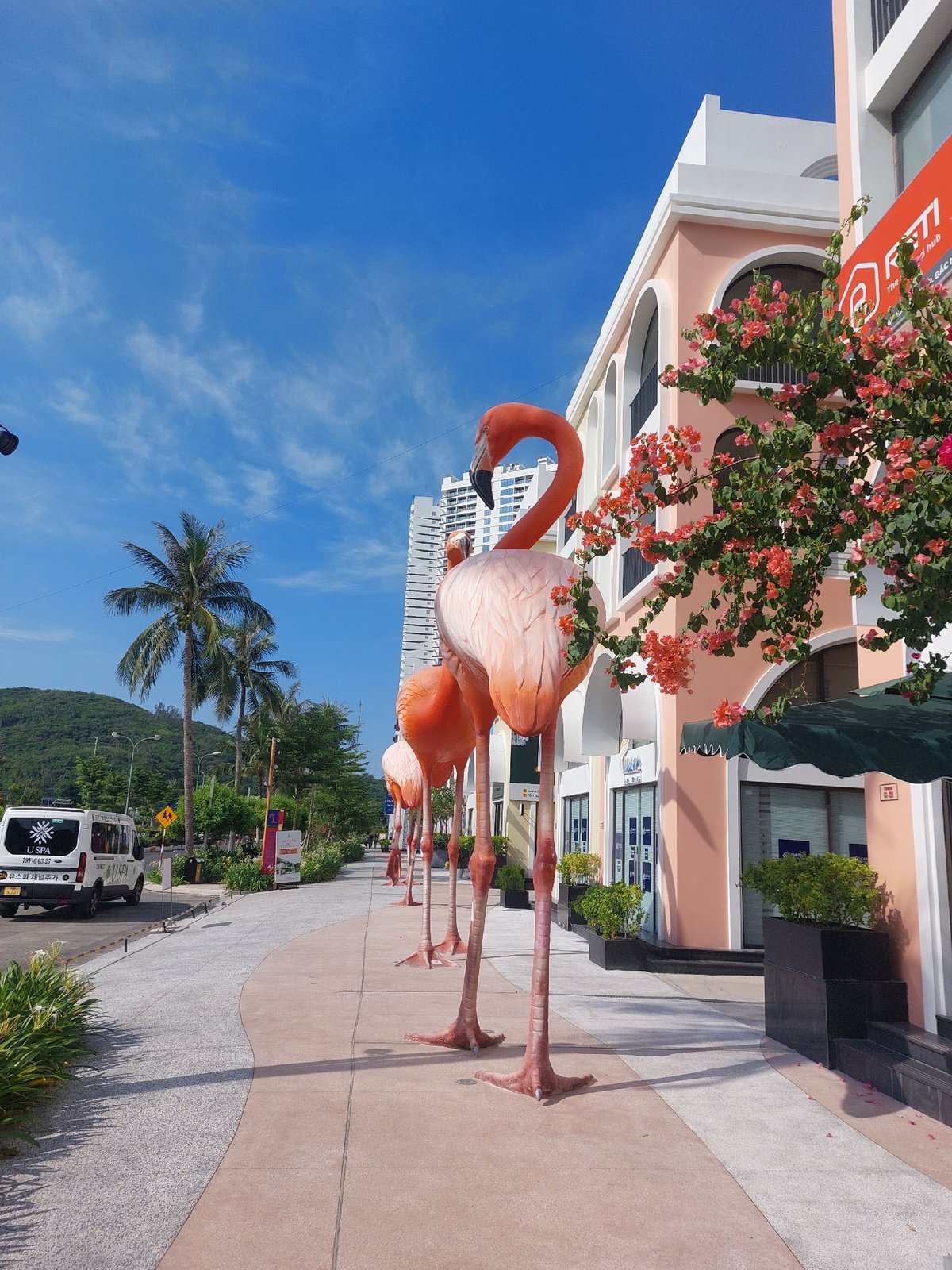 Nha Trang resort complex with sculptures, modern towers, tropical landscaping