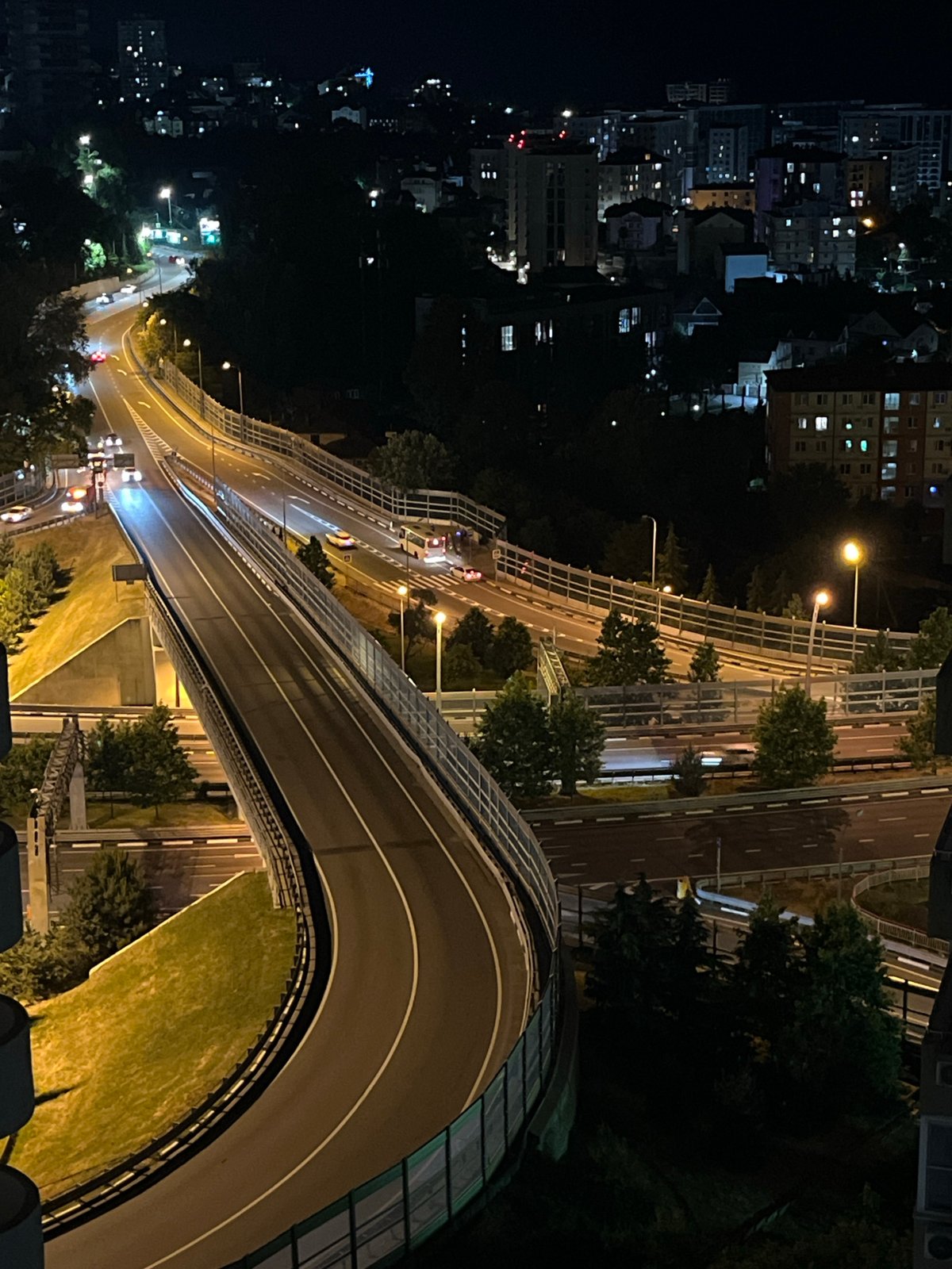 Nighttime aerial documentation of Sochi highway system and urban life