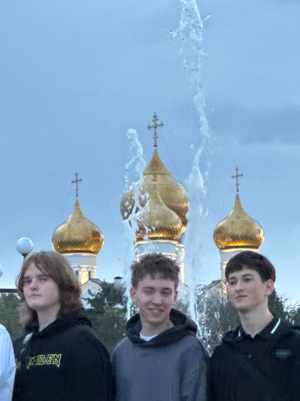 Graduation group photos near a fountain with golden domes