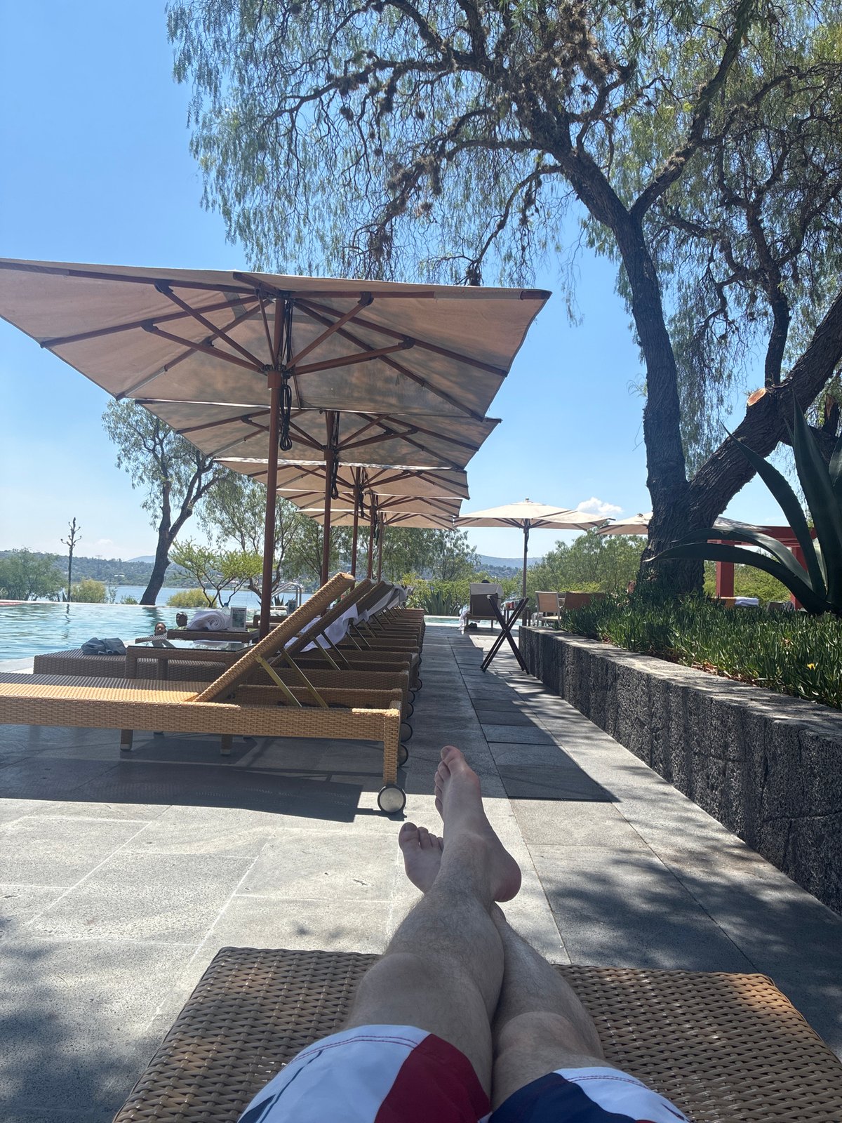 Person relaxes poolside in Pueblo Nuevo de Jasso, Mexico