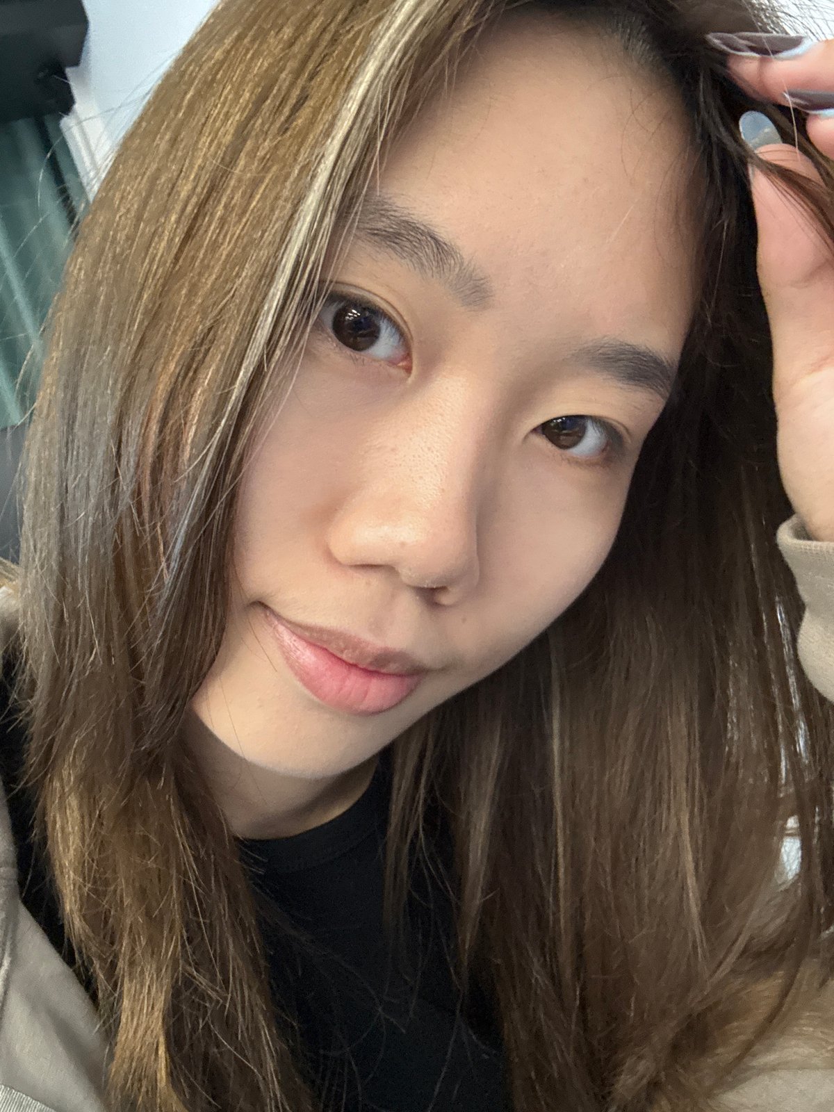 Young woman photographs herself indoors in Nan'an District