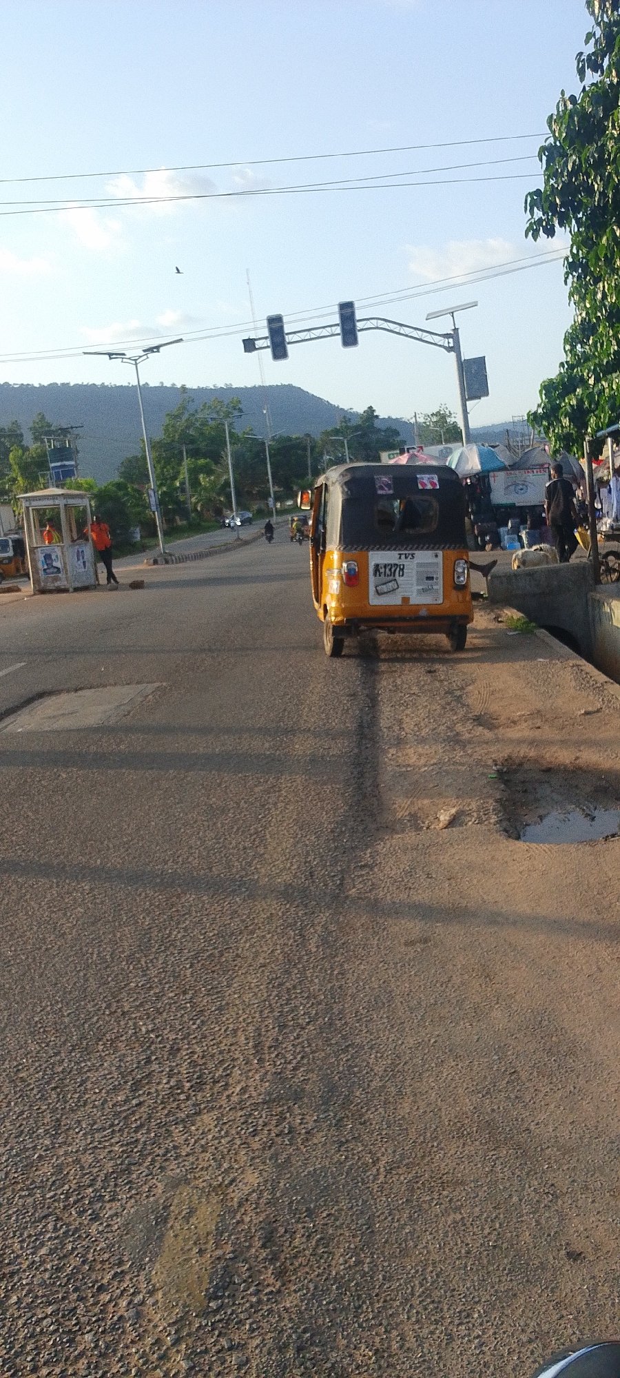 Auto-rickshaw spotted on Lokoja street under bright skies