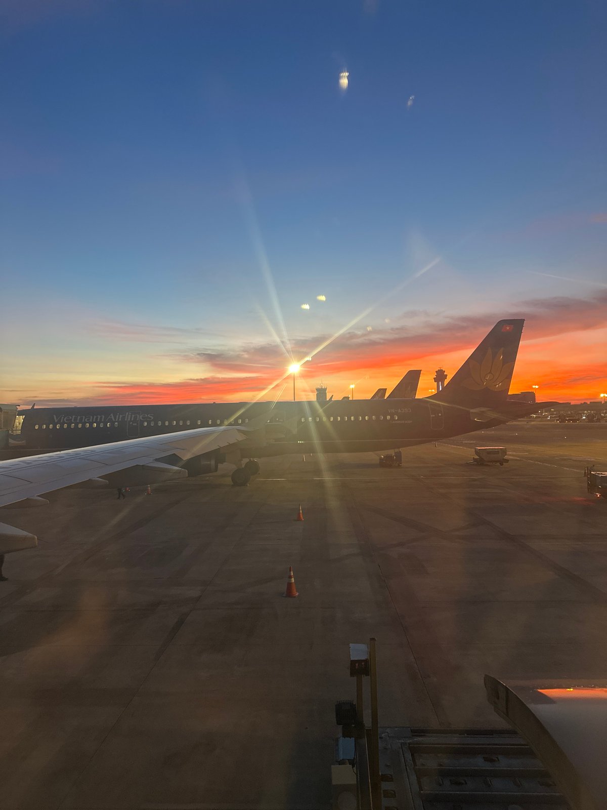 Vivid sunset colors over Thuận An airport tarmac