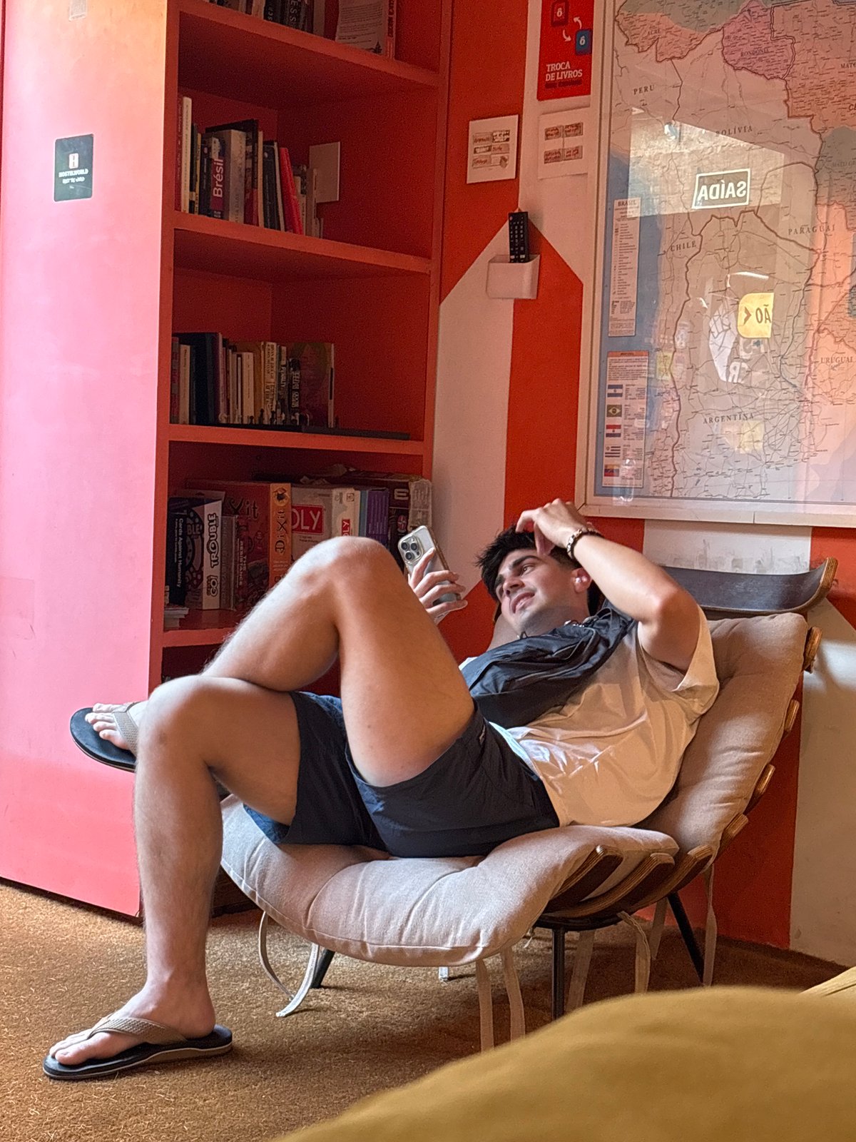 Traveler relaxes in São Paulo hostel common area