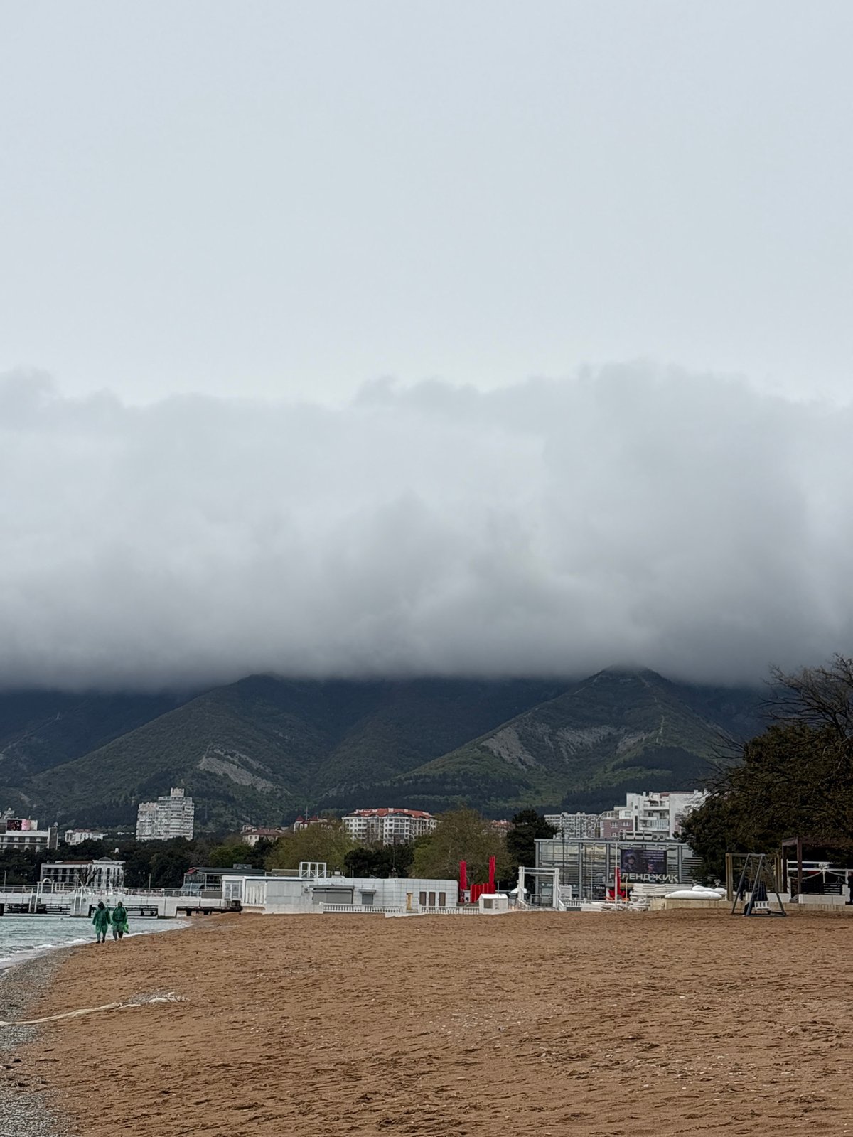 Foggy coastal landscape with beach and buildings documented