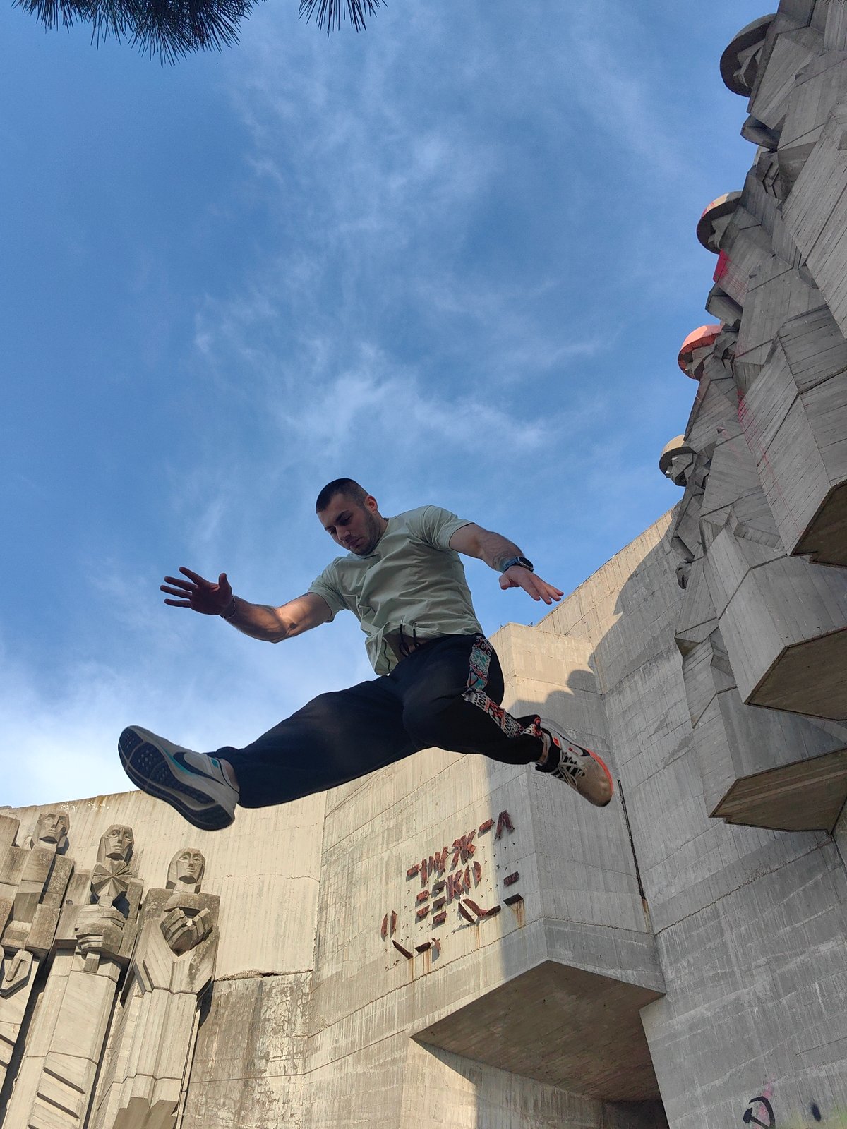 Man performs parkour stunts on concrete monument in Varna