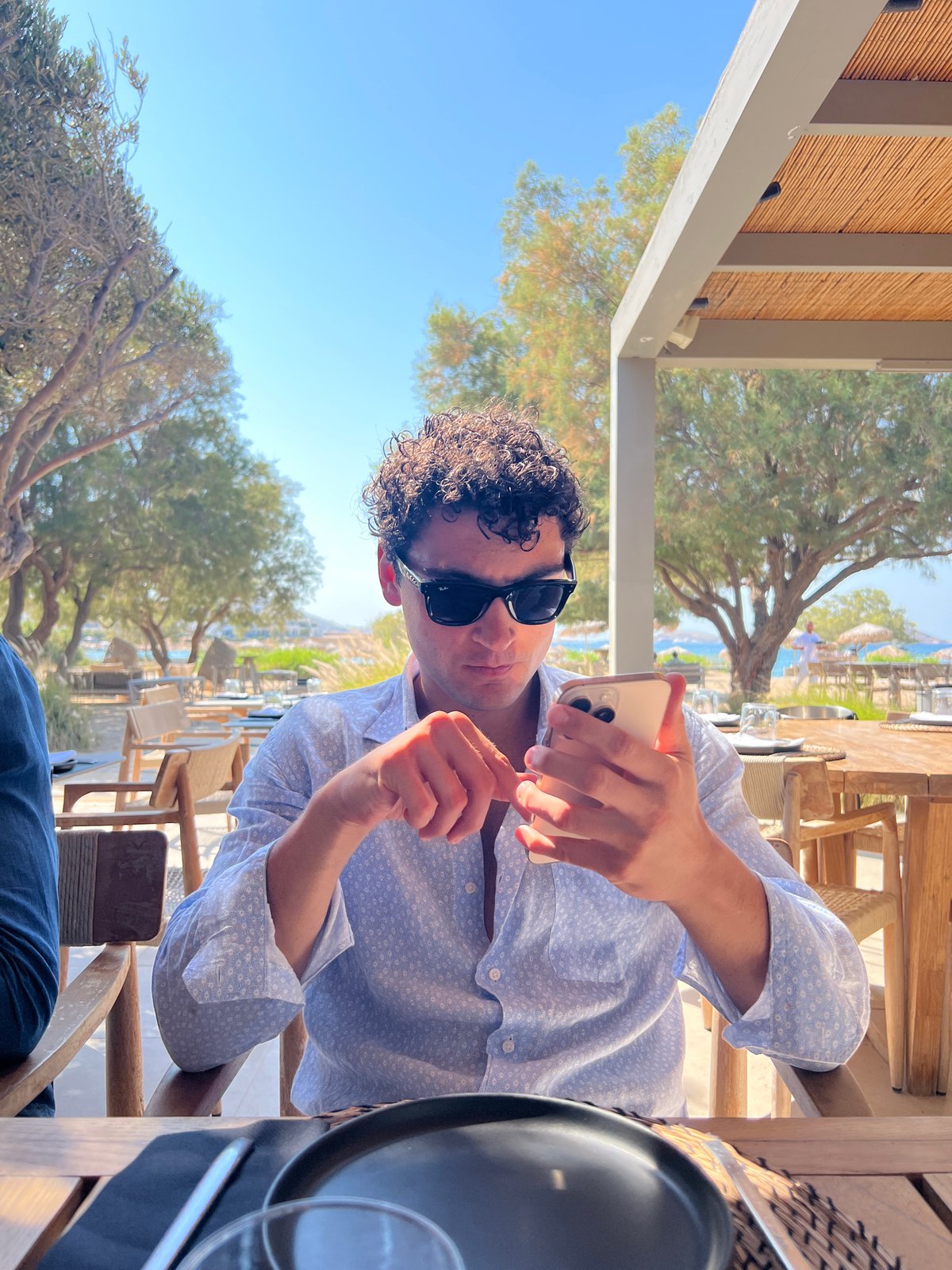 Lazy summer afternoon at a beachside café in Naousa