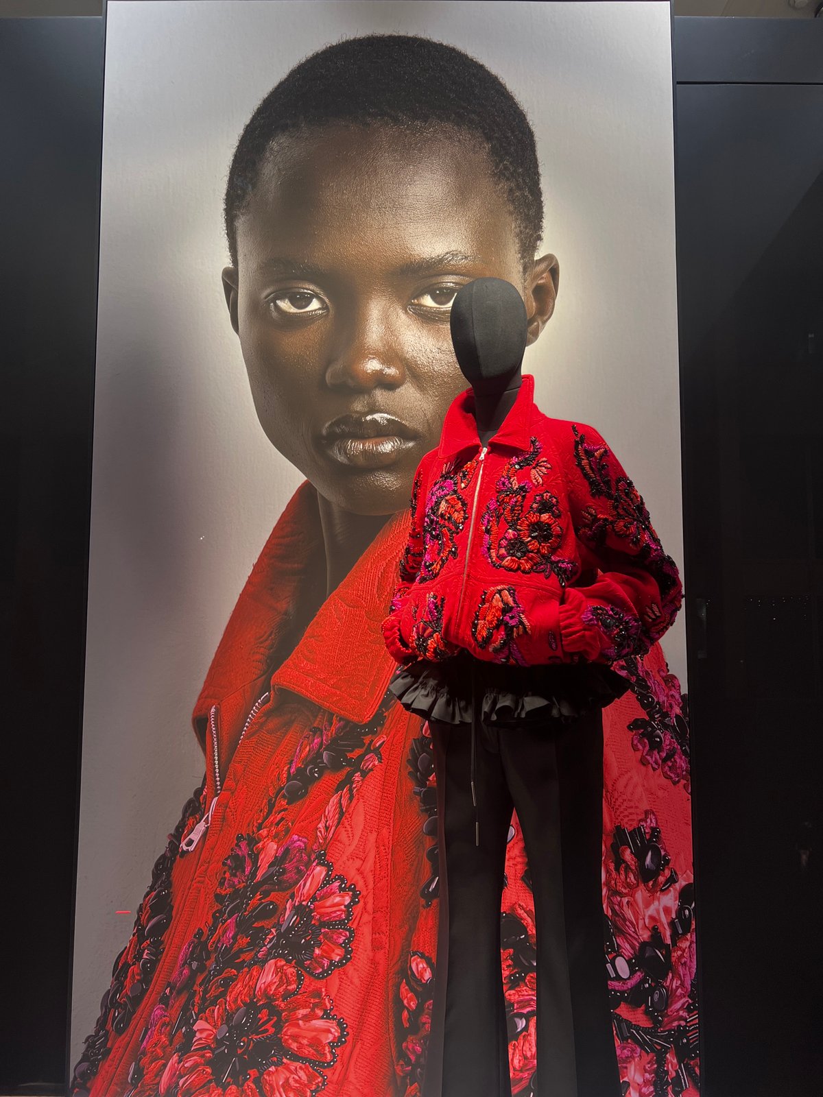 Portrait poster displayed in dimly lit Antwerp interior