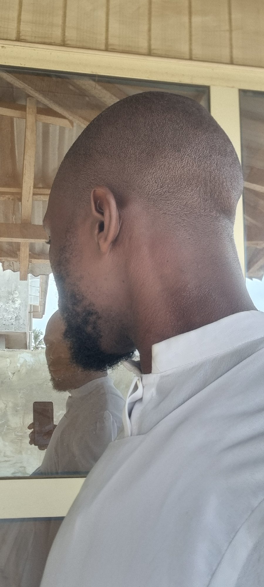 Man stands by window in Lagos building