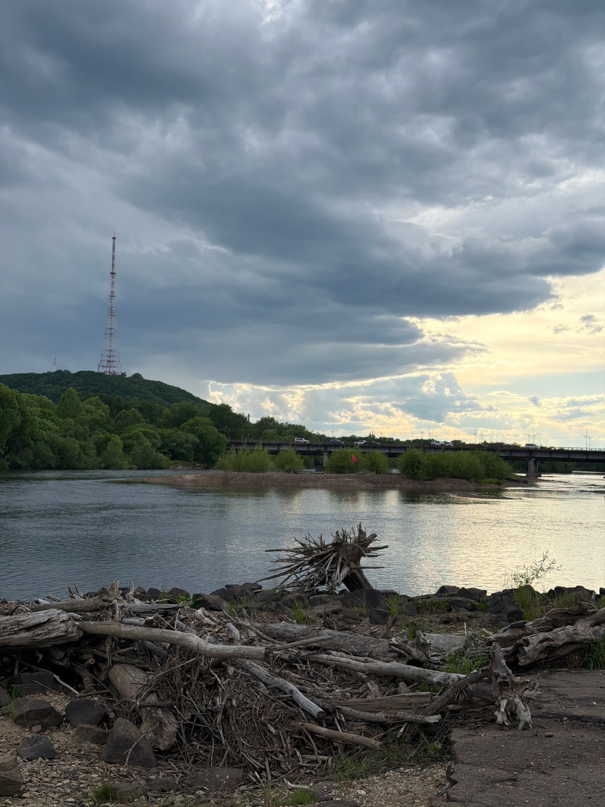 Woman photographs dramatic riverside scenery in Birobidzhan, Russia