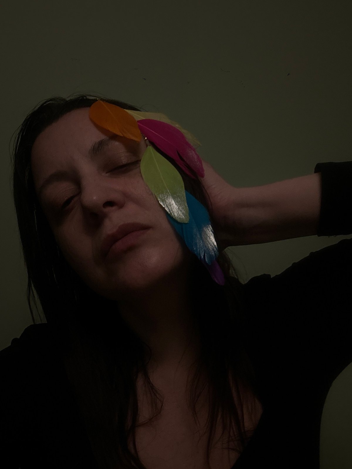 Portrait session with colorful feathers documented in Riga
