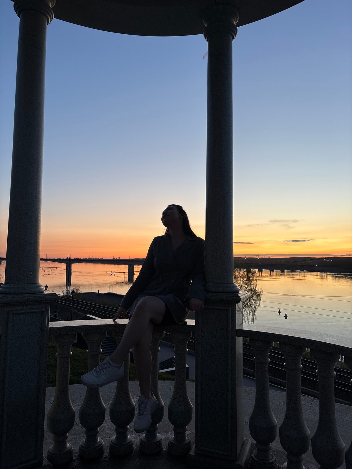 Young people gather along Kama River during sunset in Perm