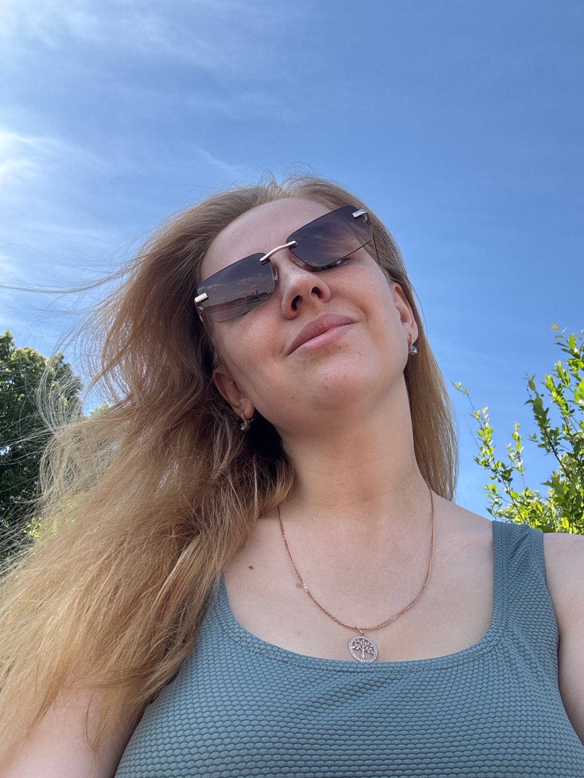 Woman and child take outdoor selfies on windy morning