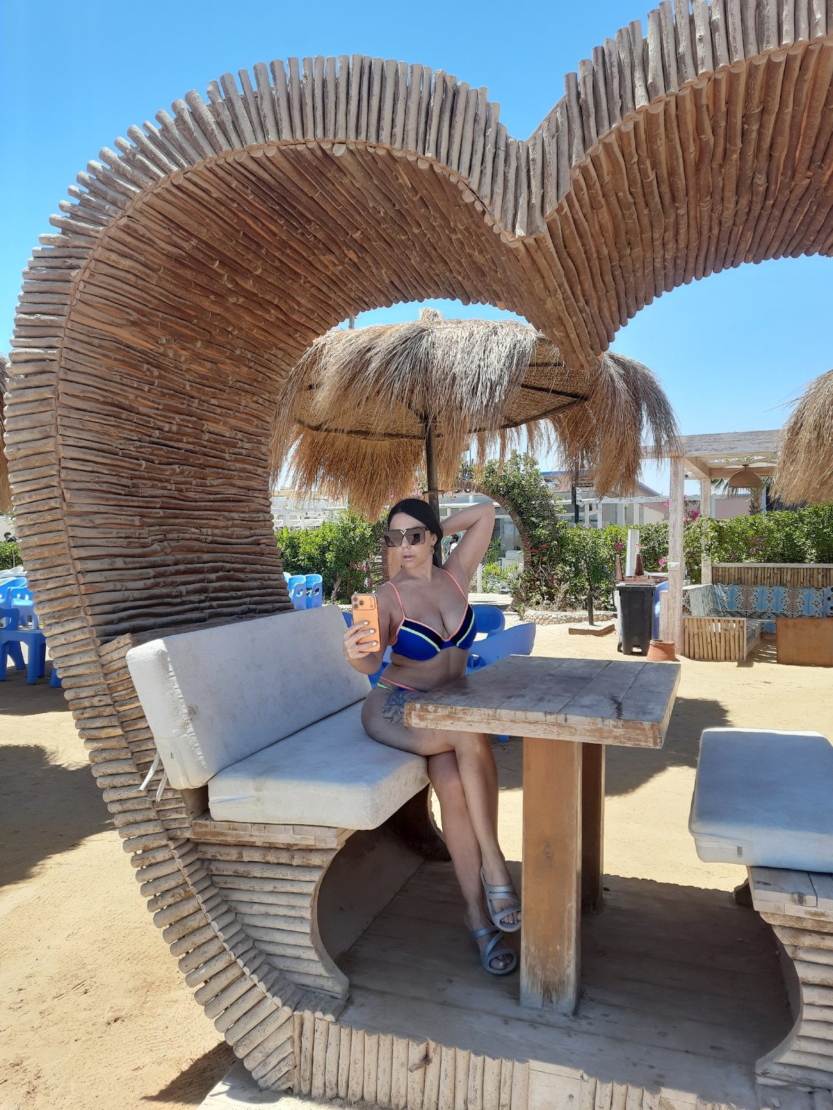 Woman relaxes in wooden shelter structure in Hurghada