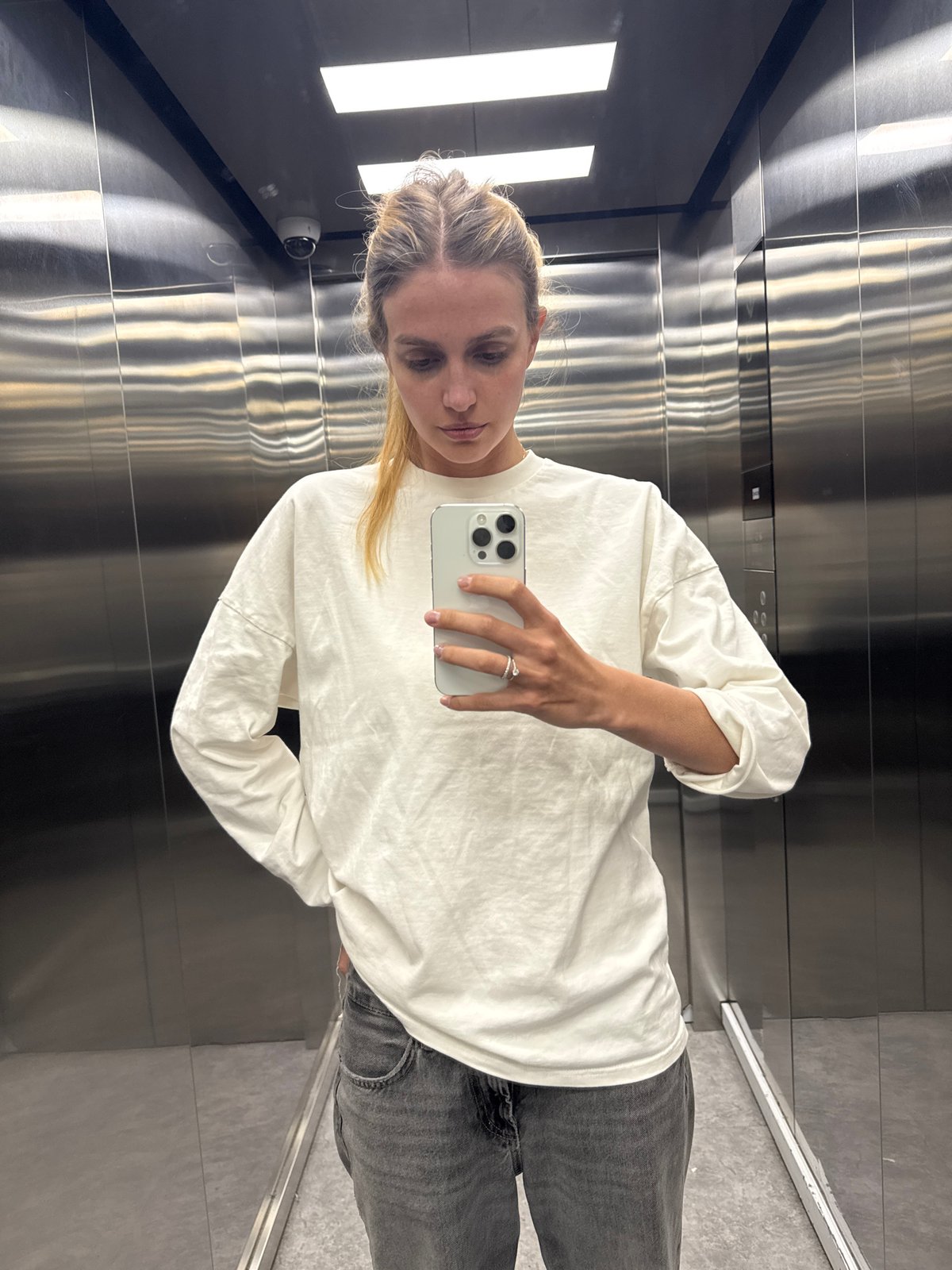 Woman Takes Selfie in Stainless Steel Elevator